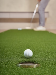 Golfer putting a ball on a green