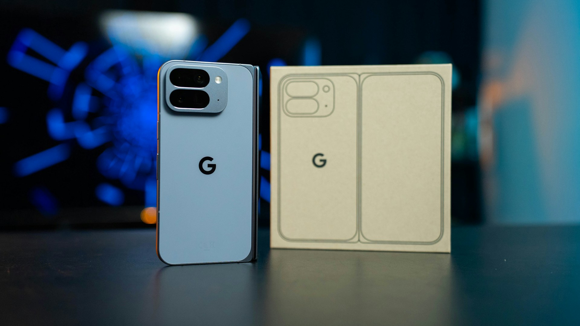 Light blue smartphone next to its packaging