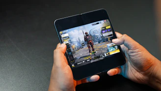 Person playing a mobile game on a foldable phone