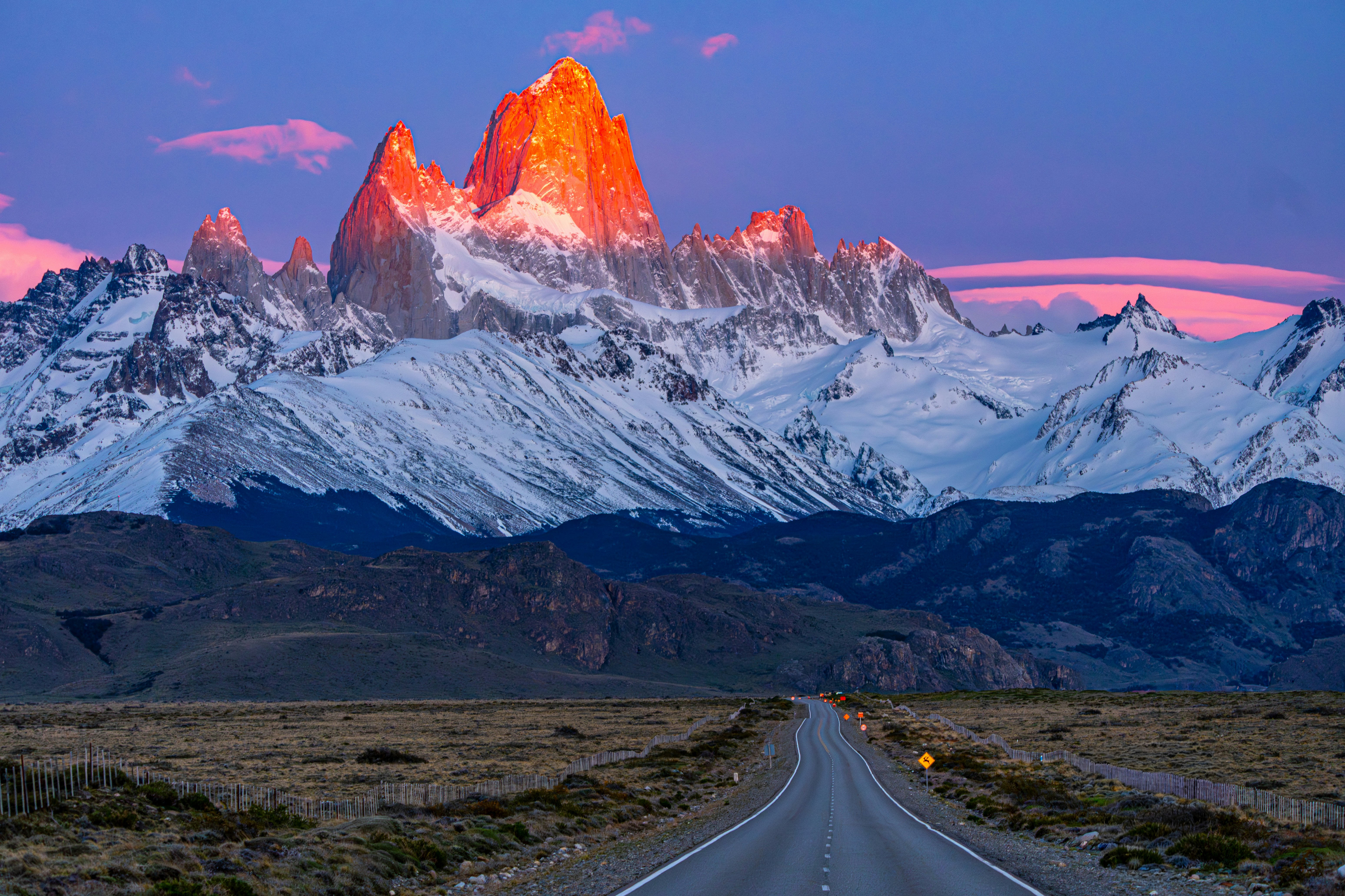 Majestic snow-capped mountains illuminated by sunset light.
