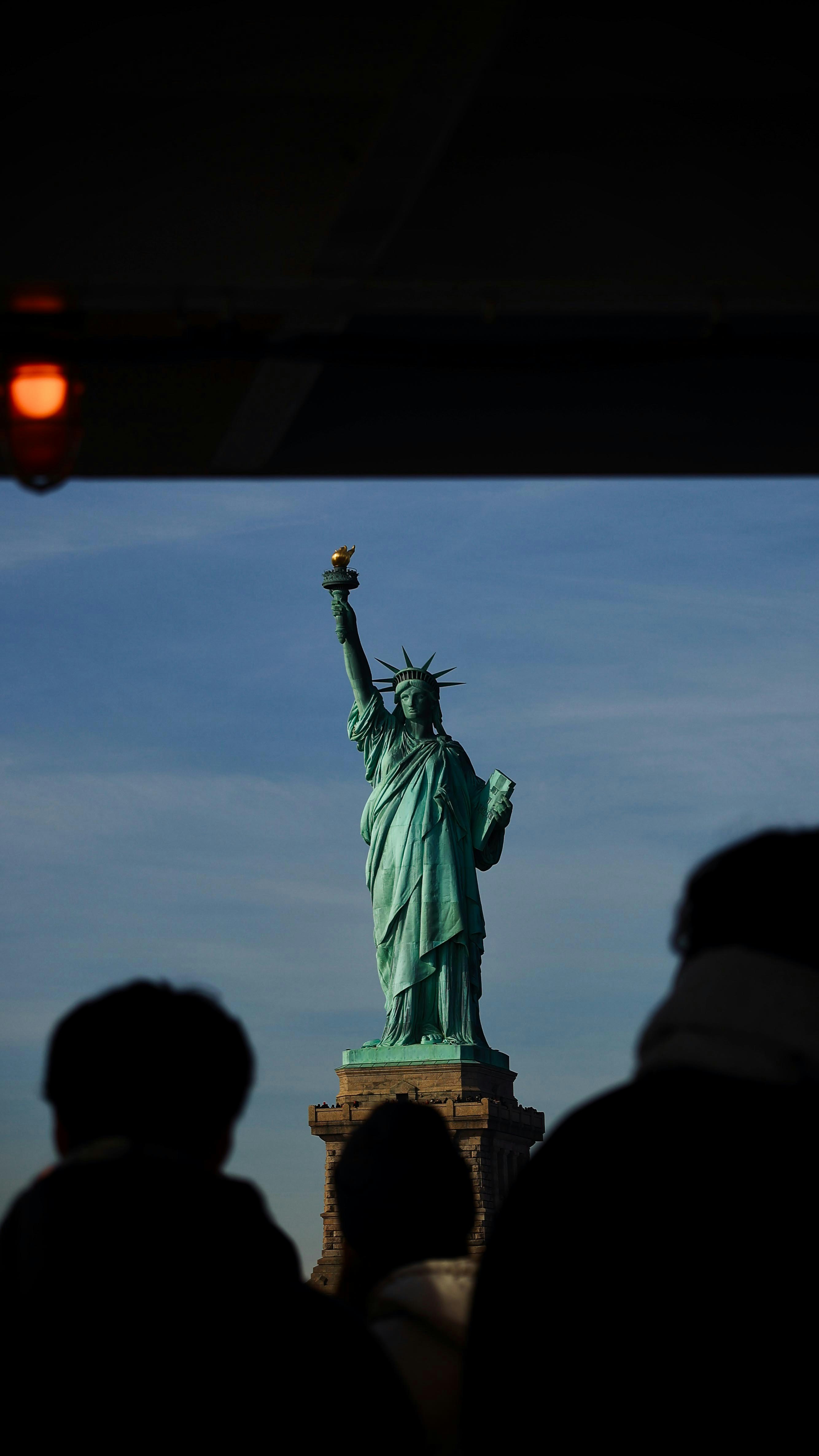 Statue of liberty with people in foreground