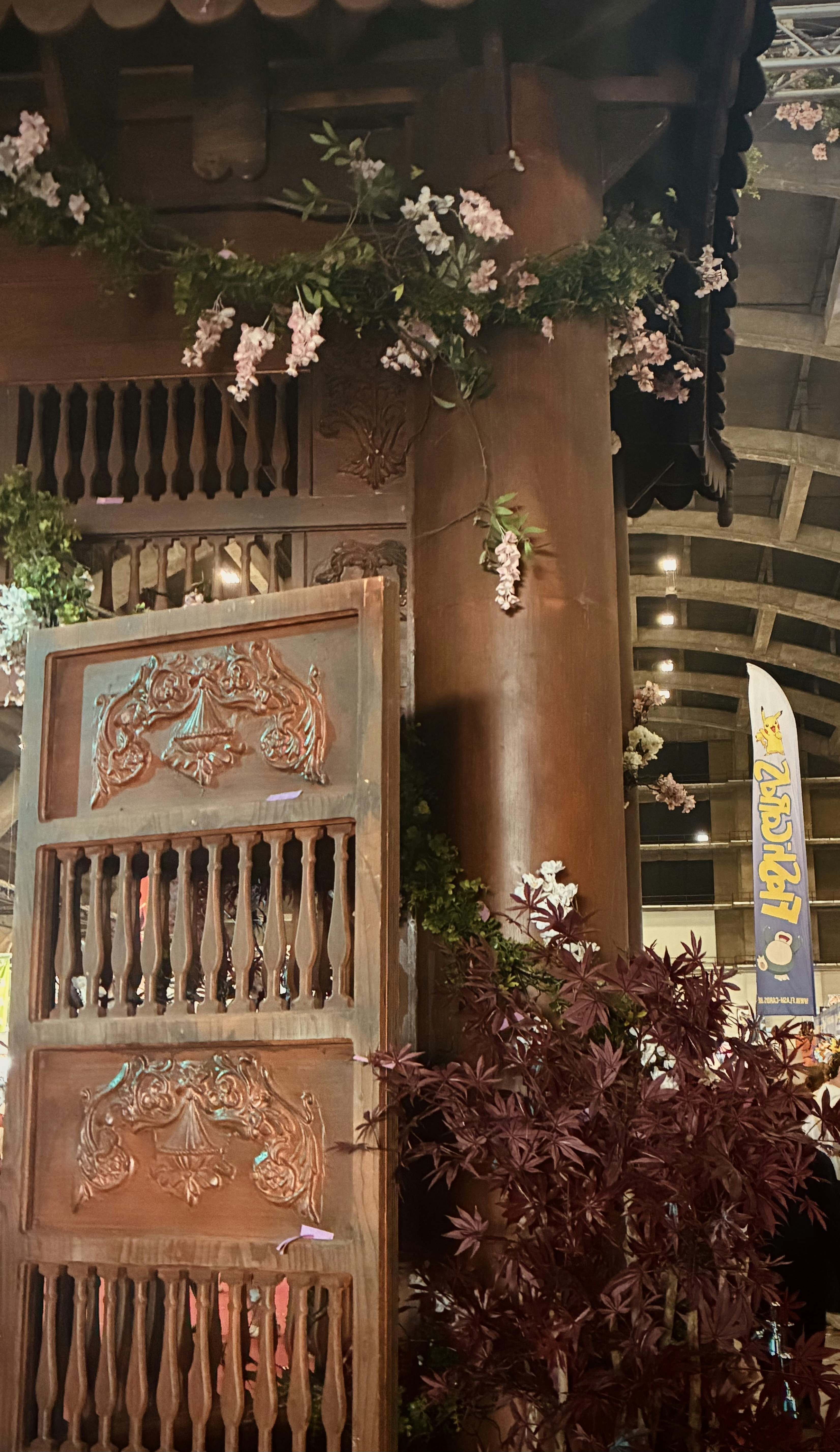 Wooden gate with floral decorations and red foliage