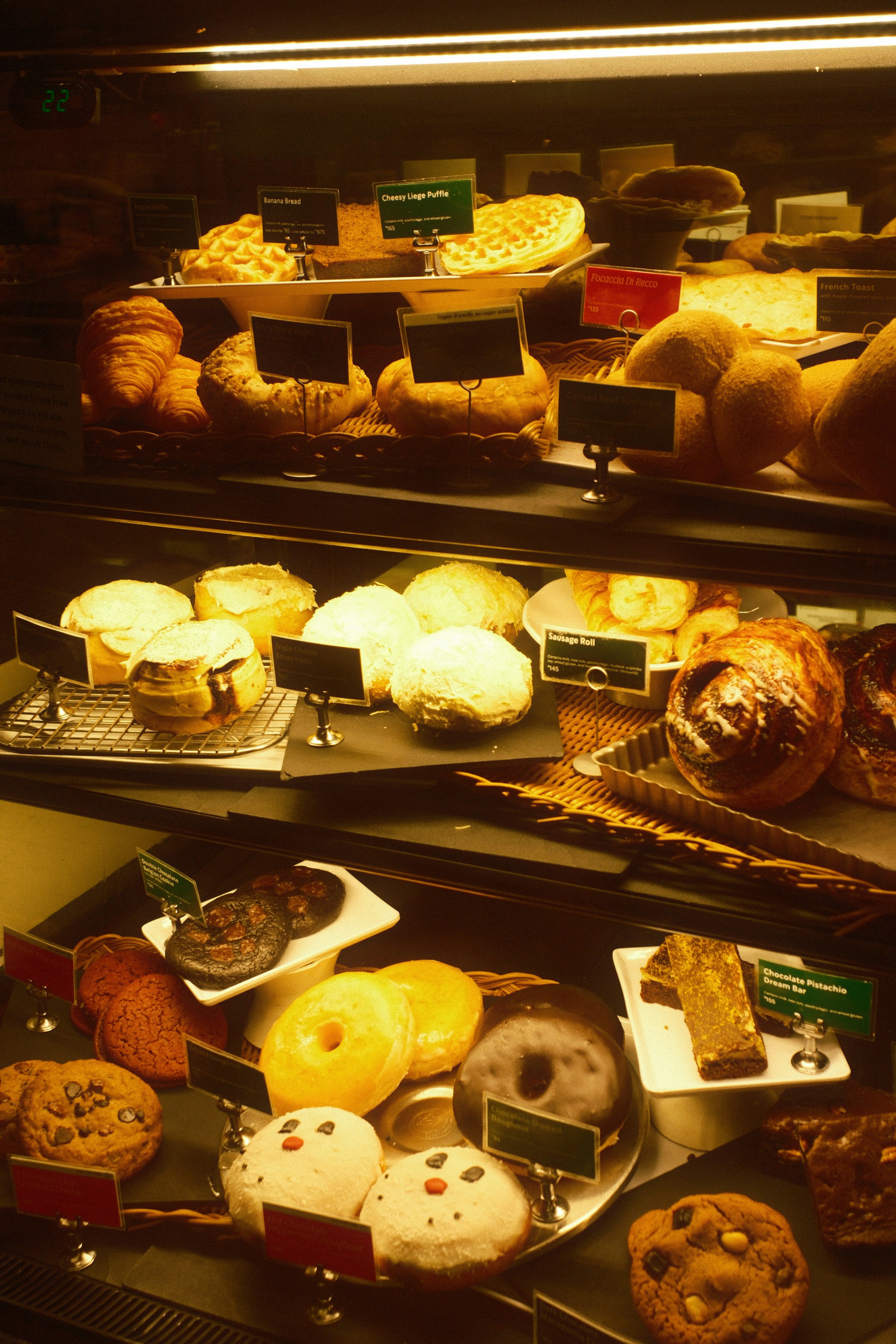 Assortment of pastries and donuts in a display case.