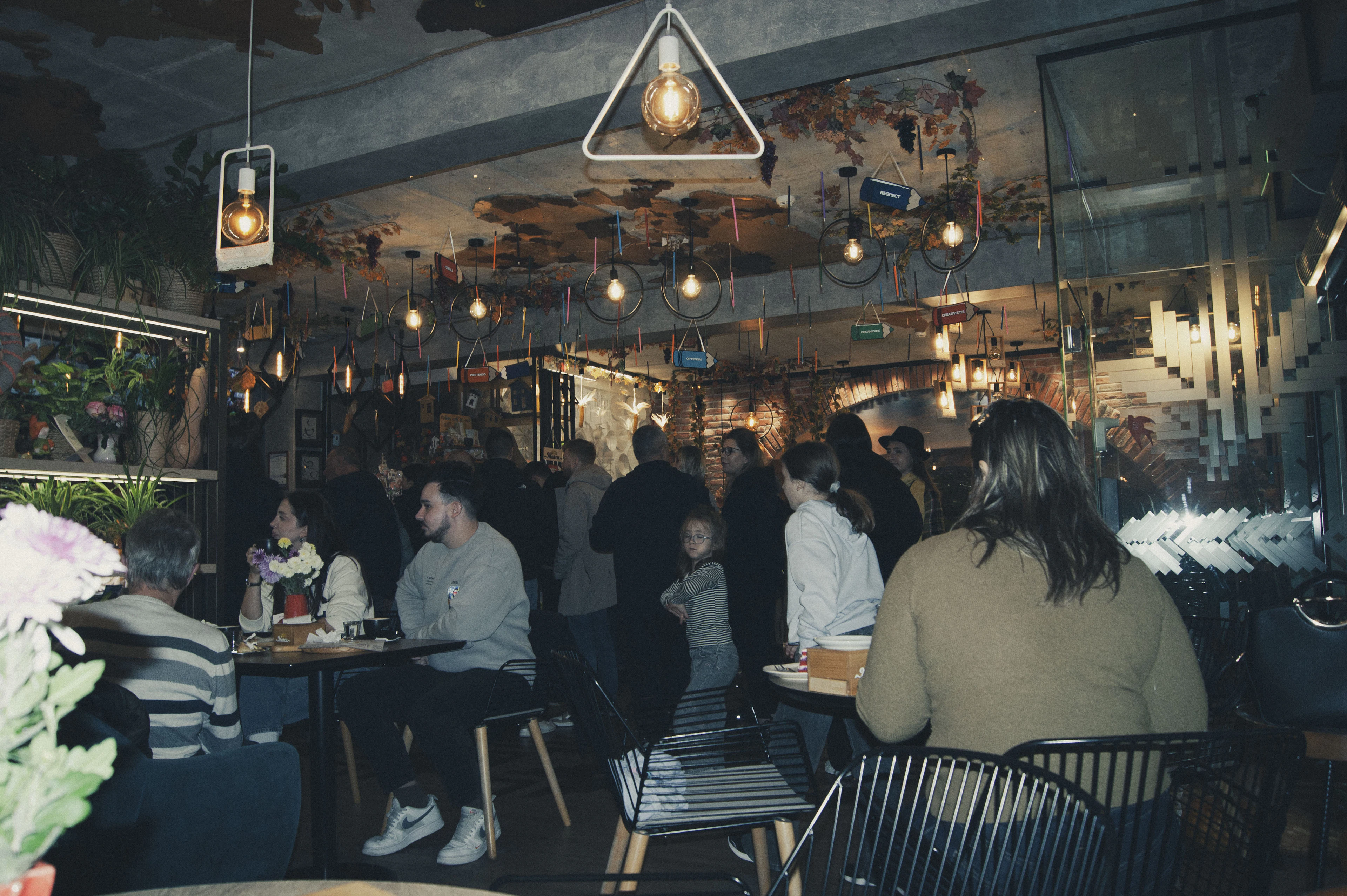Guests gathered under warm hanging lights after hours