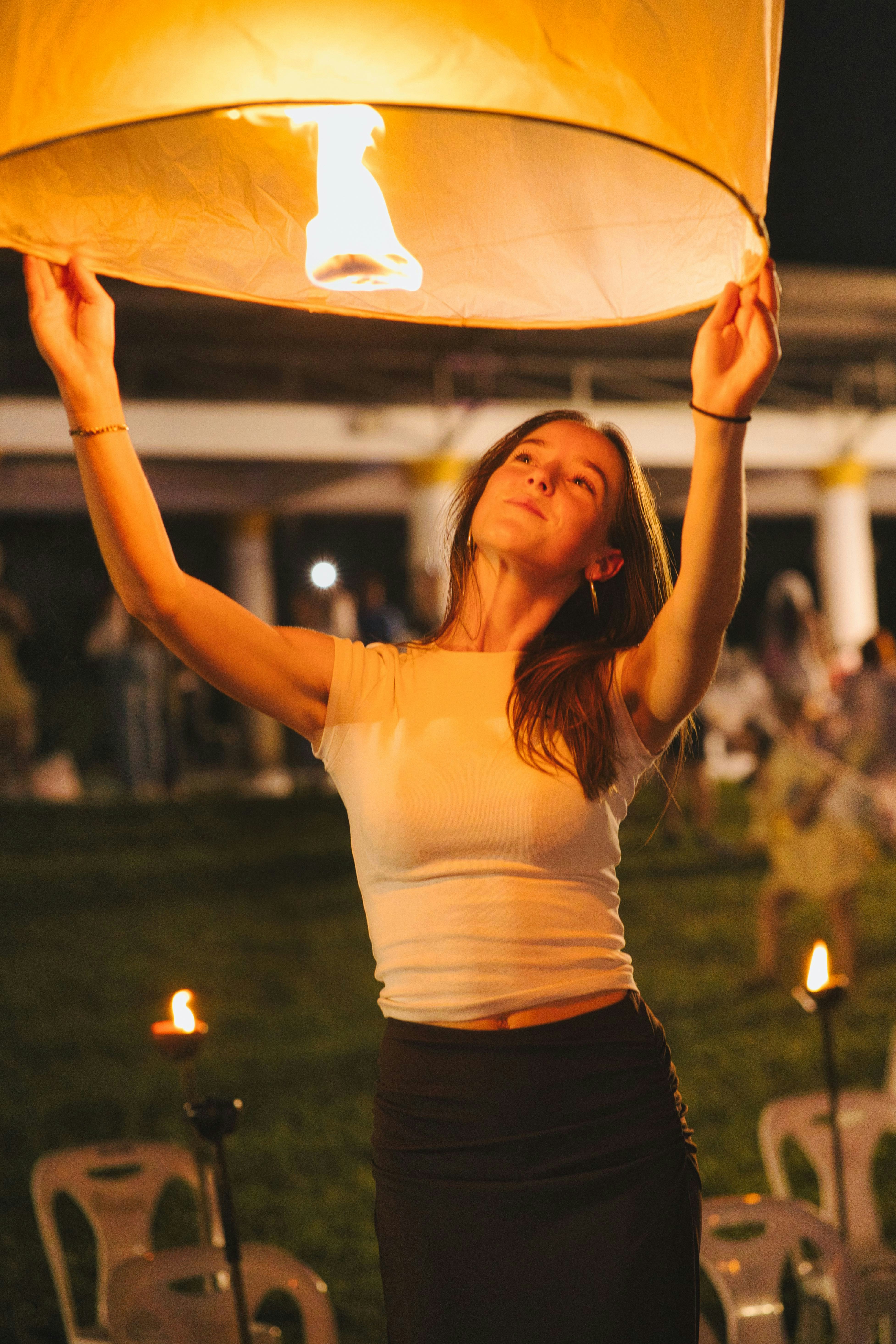 Woman holding a lit lantern at night photo – Free Night Image on Unsplash