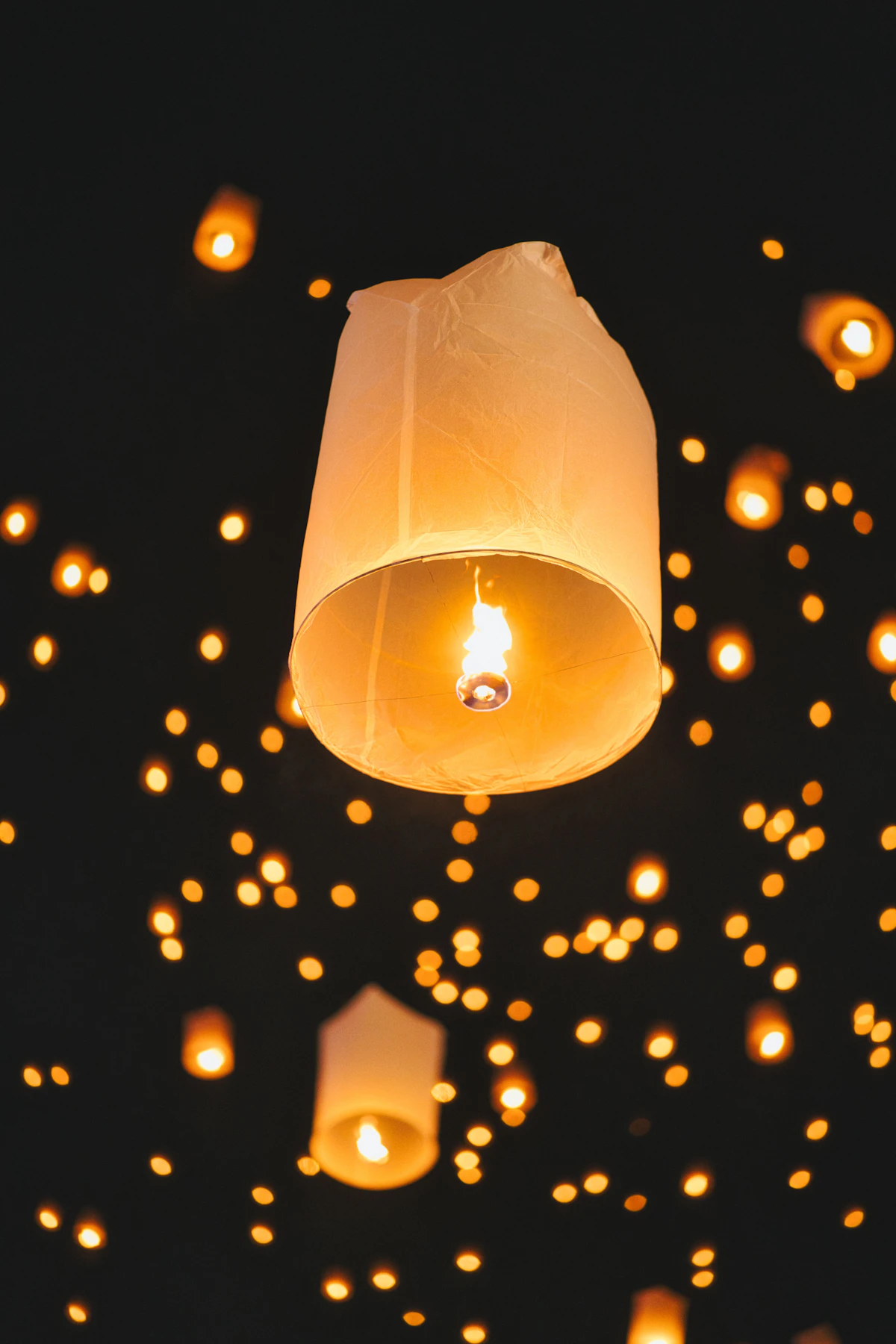 Sky lanterns rising into the night over Chiang Mai