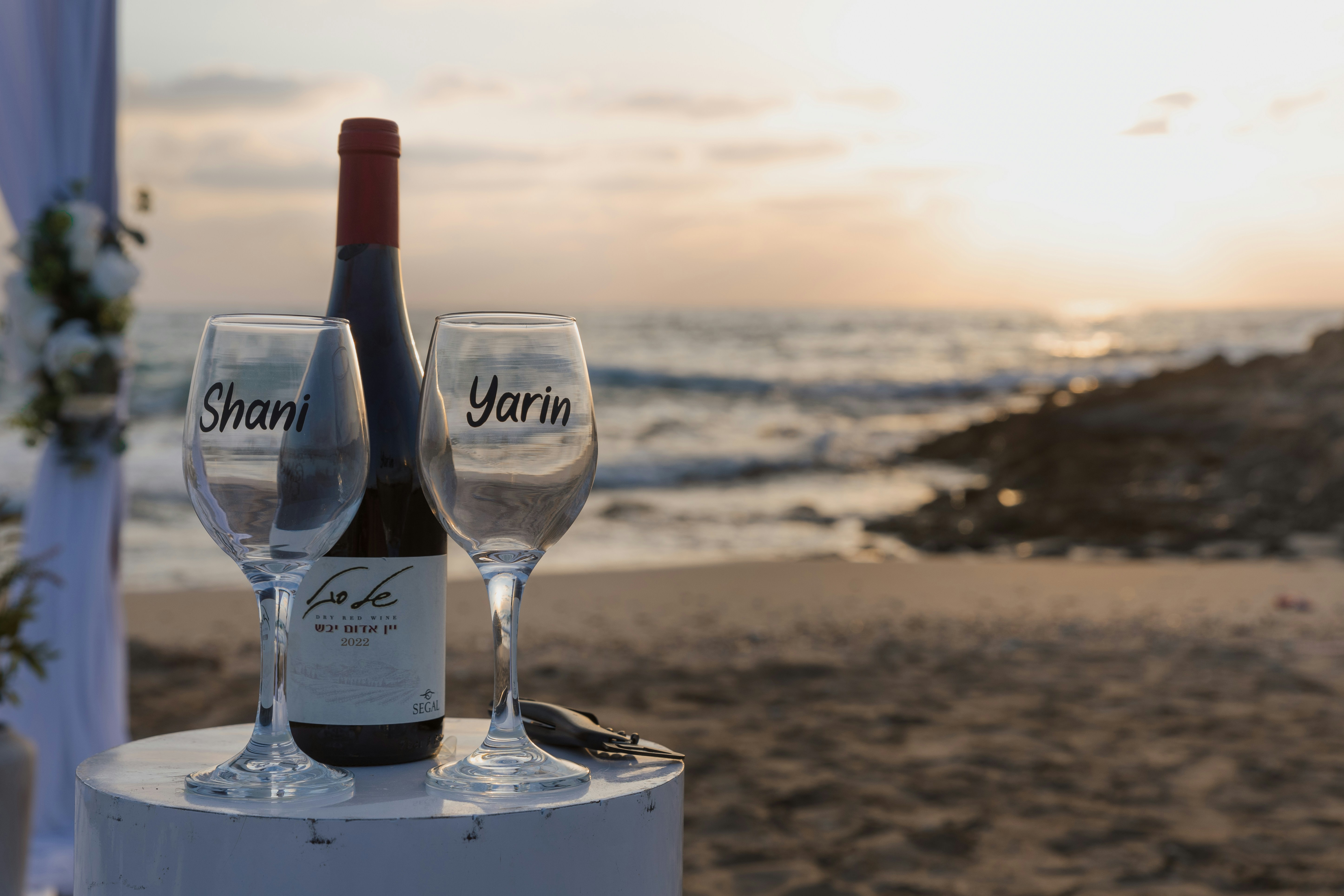 Wedding glasses and wine bottle on beach at beach