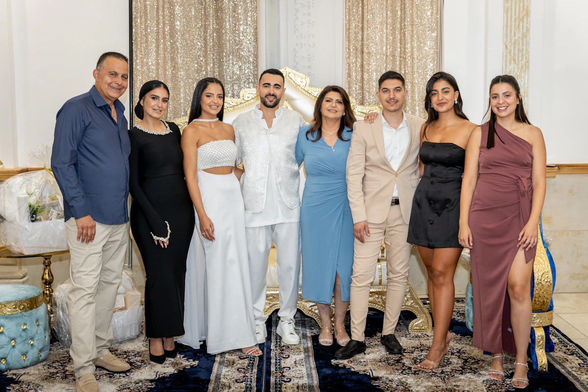 A group of people posing together at a formal gathering