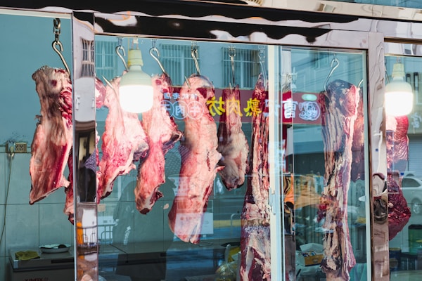 Dry-aged beef hanging in the window of Trenchard & Sons