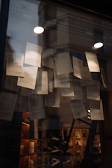 Papers taped to a window reflecting lights and obscuring interior.