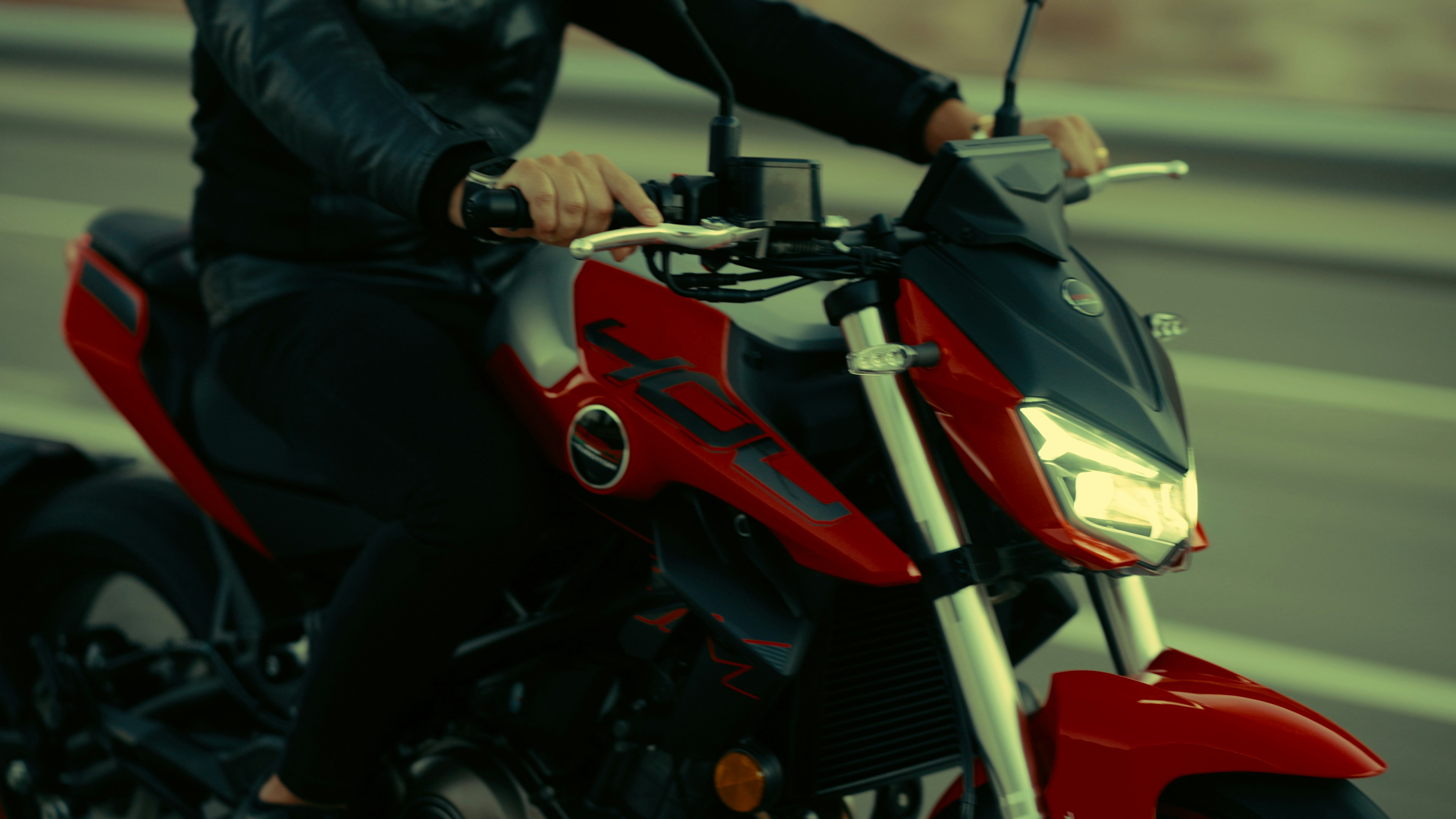 Rider on a red motorcycle on a road