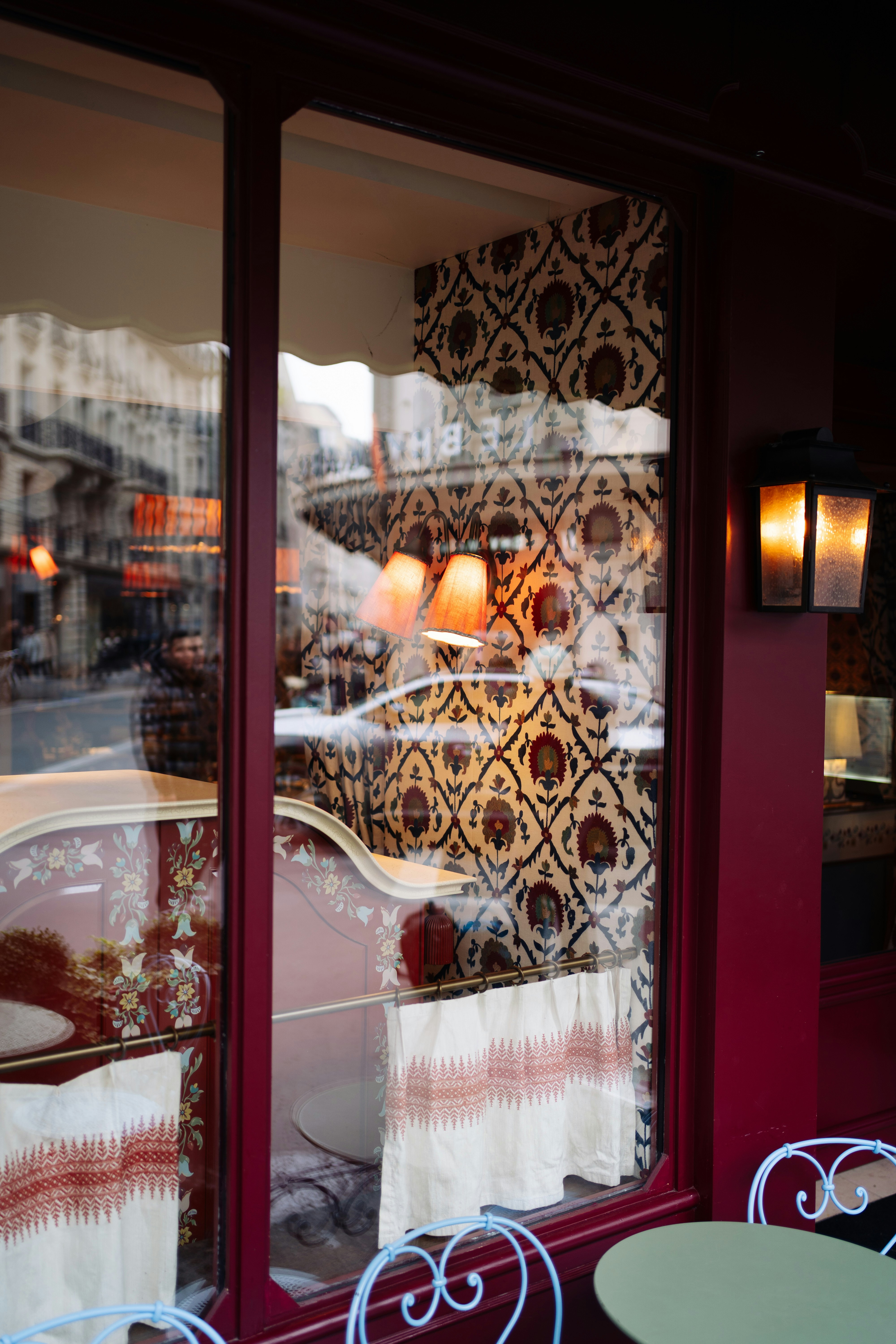 Cafe window display with ornate wallpaper and seating
