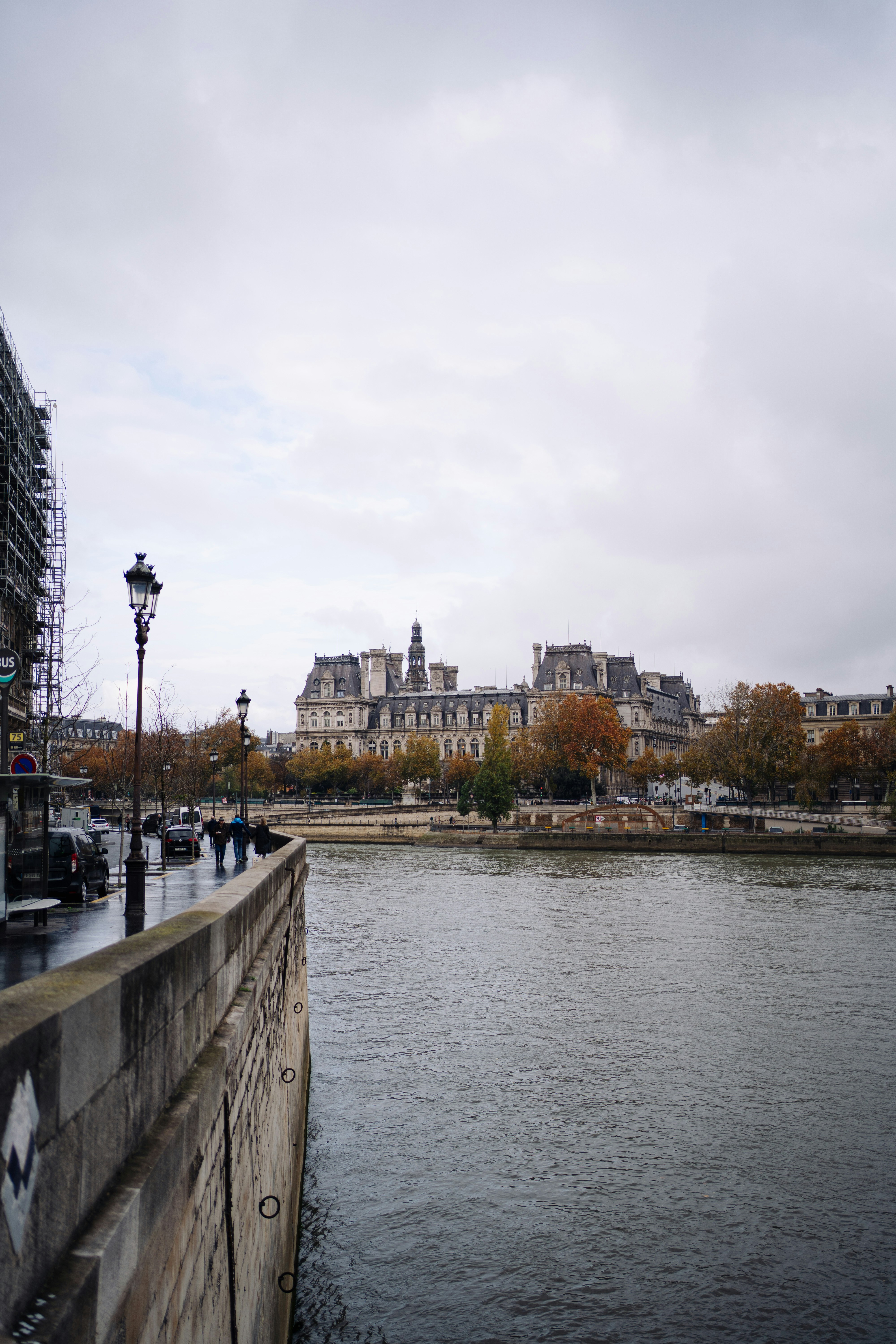 Parisian buildings along the seine river on a cloudy day.