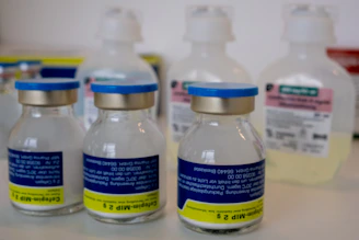 Several medical vials and bottles on a shelf.