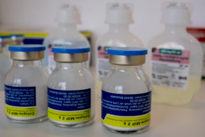 Several medical vials and bottles on a shelf.