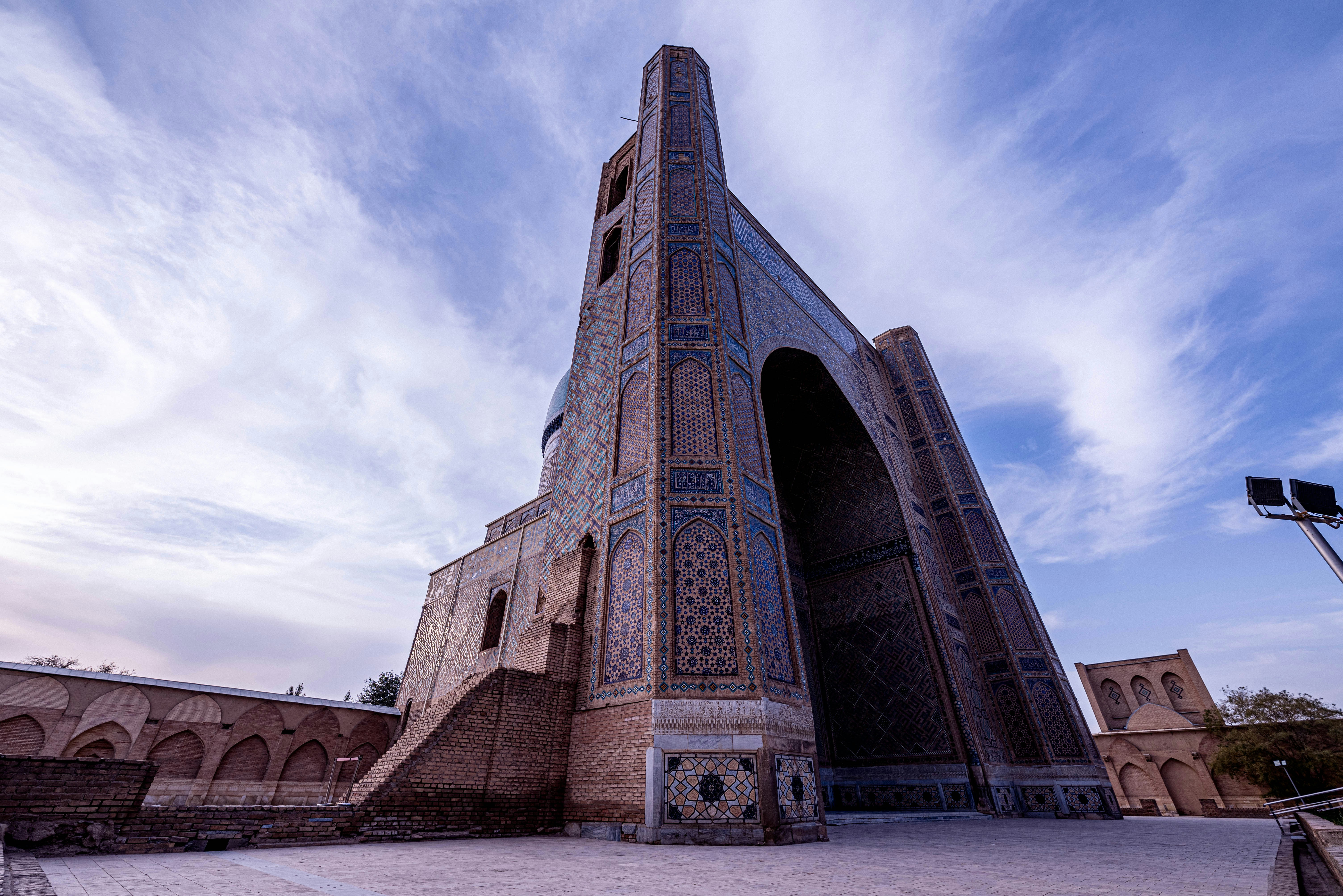 Ancient brick structure with arched entrance against sky