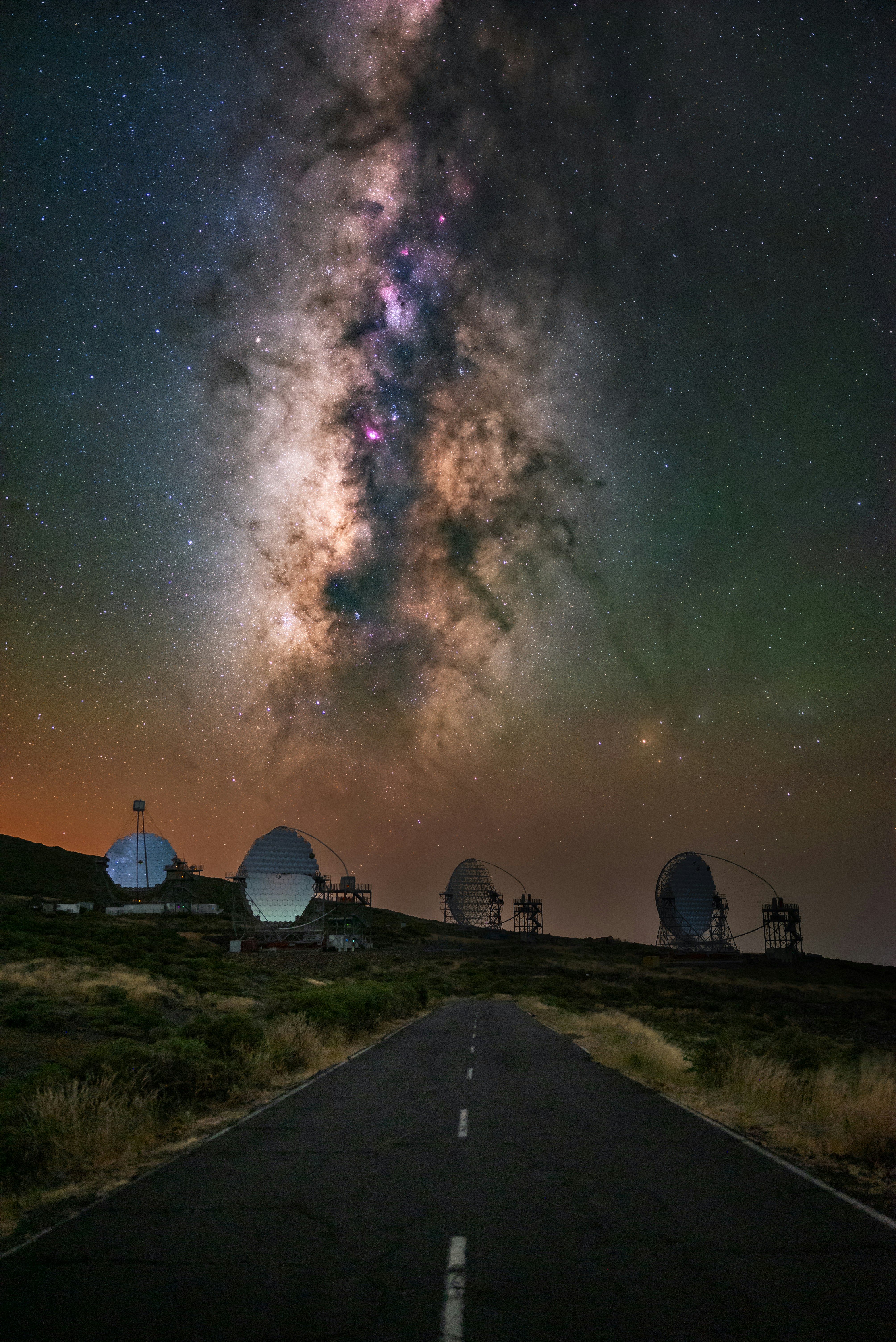 Observatory dishes under the milky way galaxy