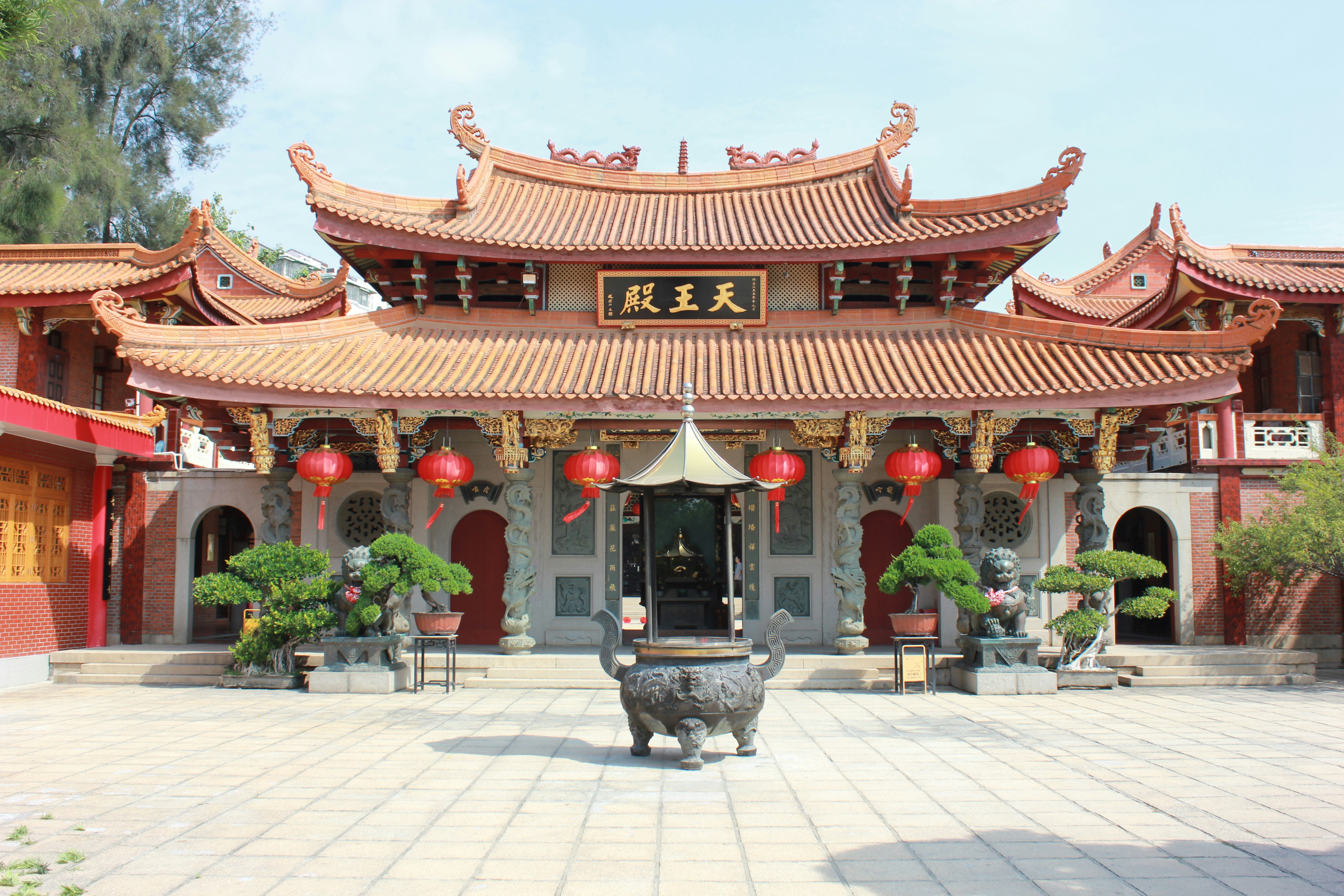 The Hall of Celestial Kings (Tian Wang Dian) at the Siong Lim Temple (Lian Shan Shuang Lin Monastery), a traditional Chinese Buddhist monastery in Singapore with bonsai trees.