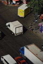 Trucks and cars on a city street intersection.