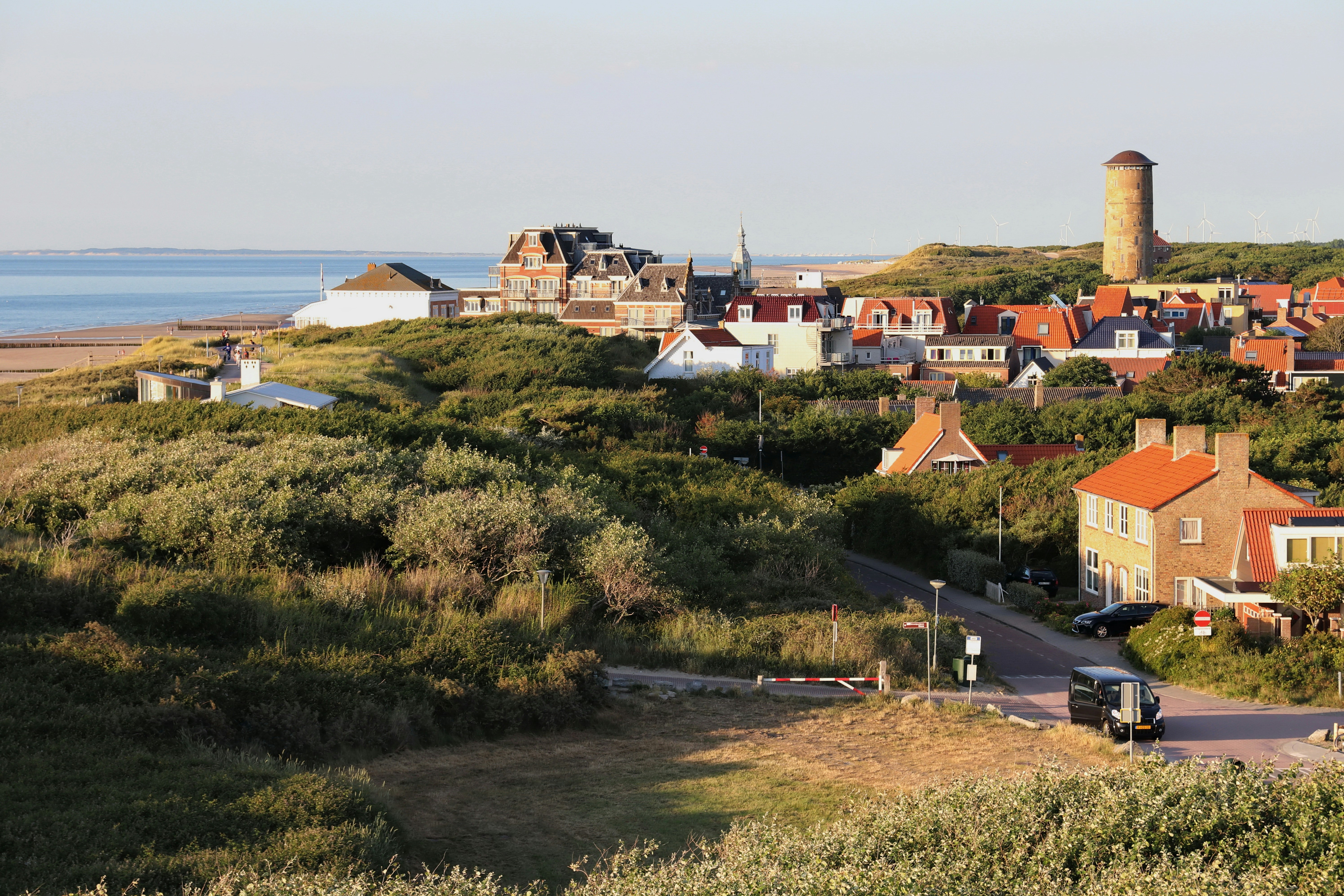 Coastal village with lighthouse and ocean view.