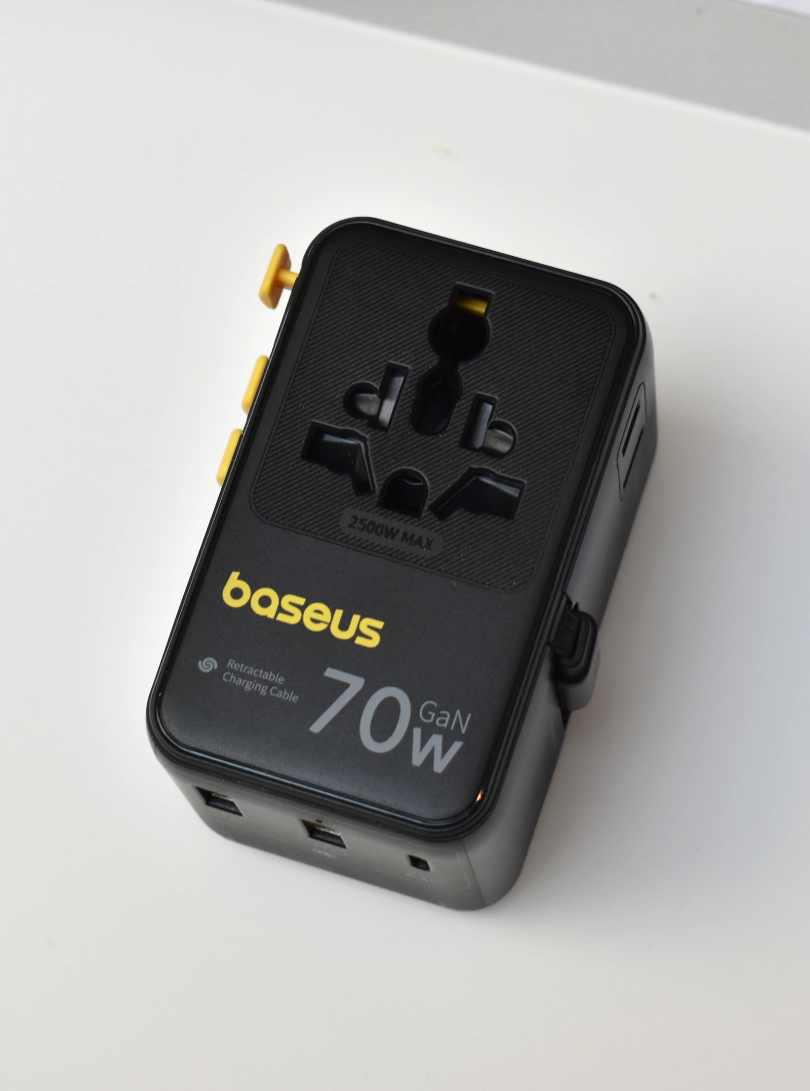 A compact multi-port GAN charging adapter — one small brick, several different outputs, which is exactly the pitch behind a library that puts several AI backends behind one Swift interface.