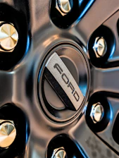 Close-up of a ford car wheel emblem.