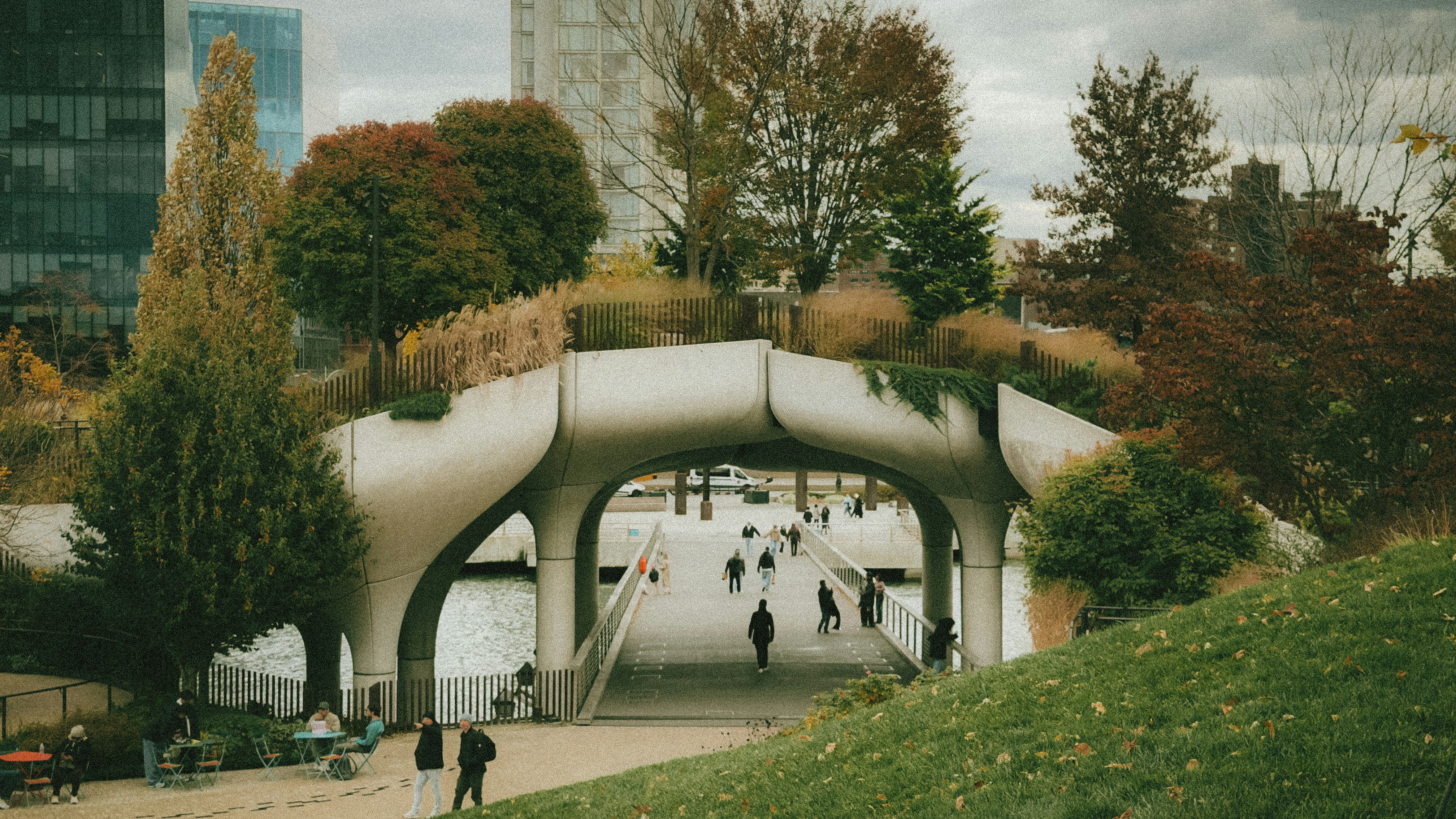 People walking on a modern elevated park walkway