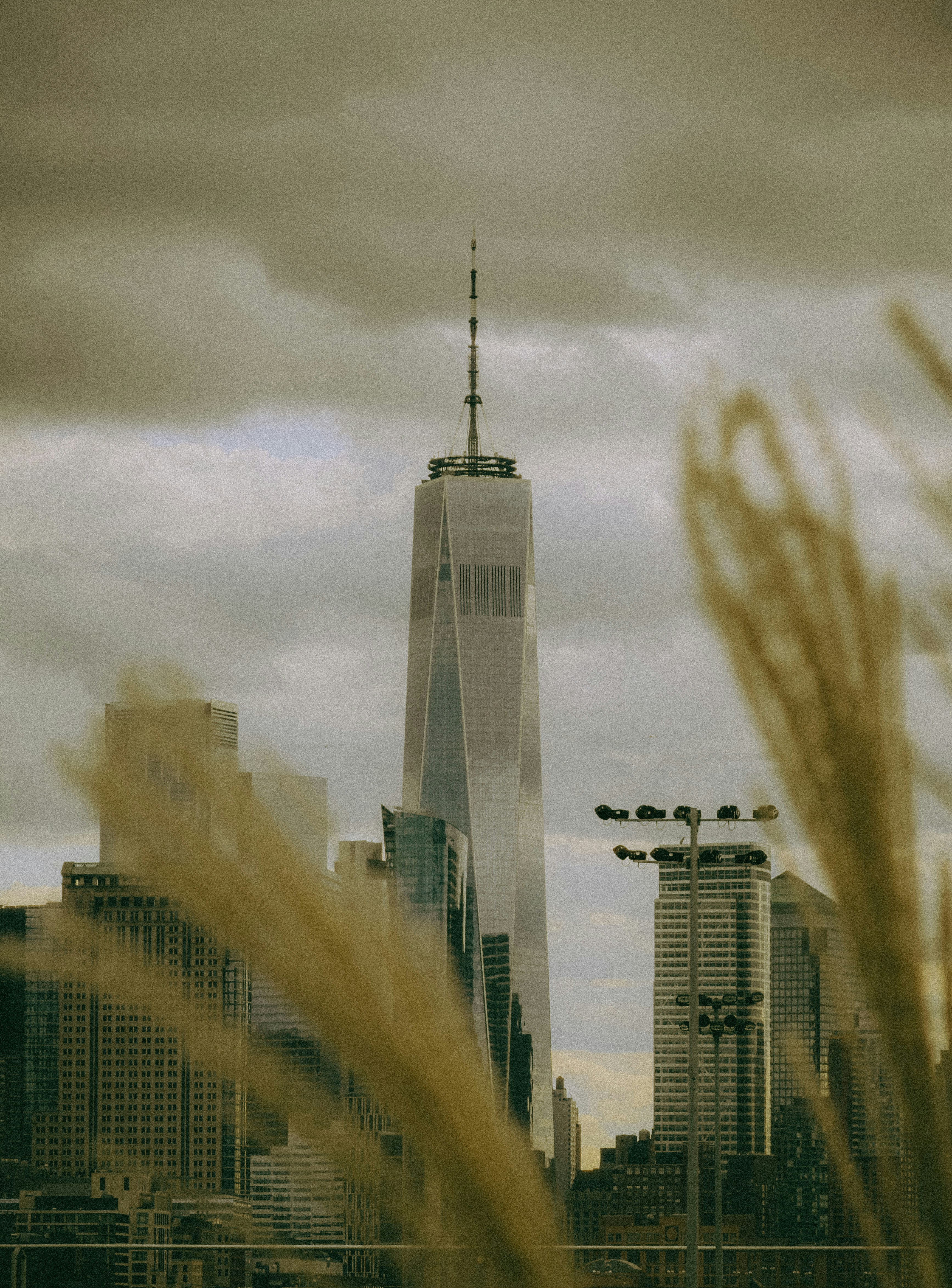 One world trade center skyscraper against cloudy sky