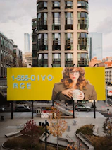 Billboard with woman holding mug and phone number