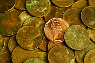 Pile of lincoln pennies with one prominent