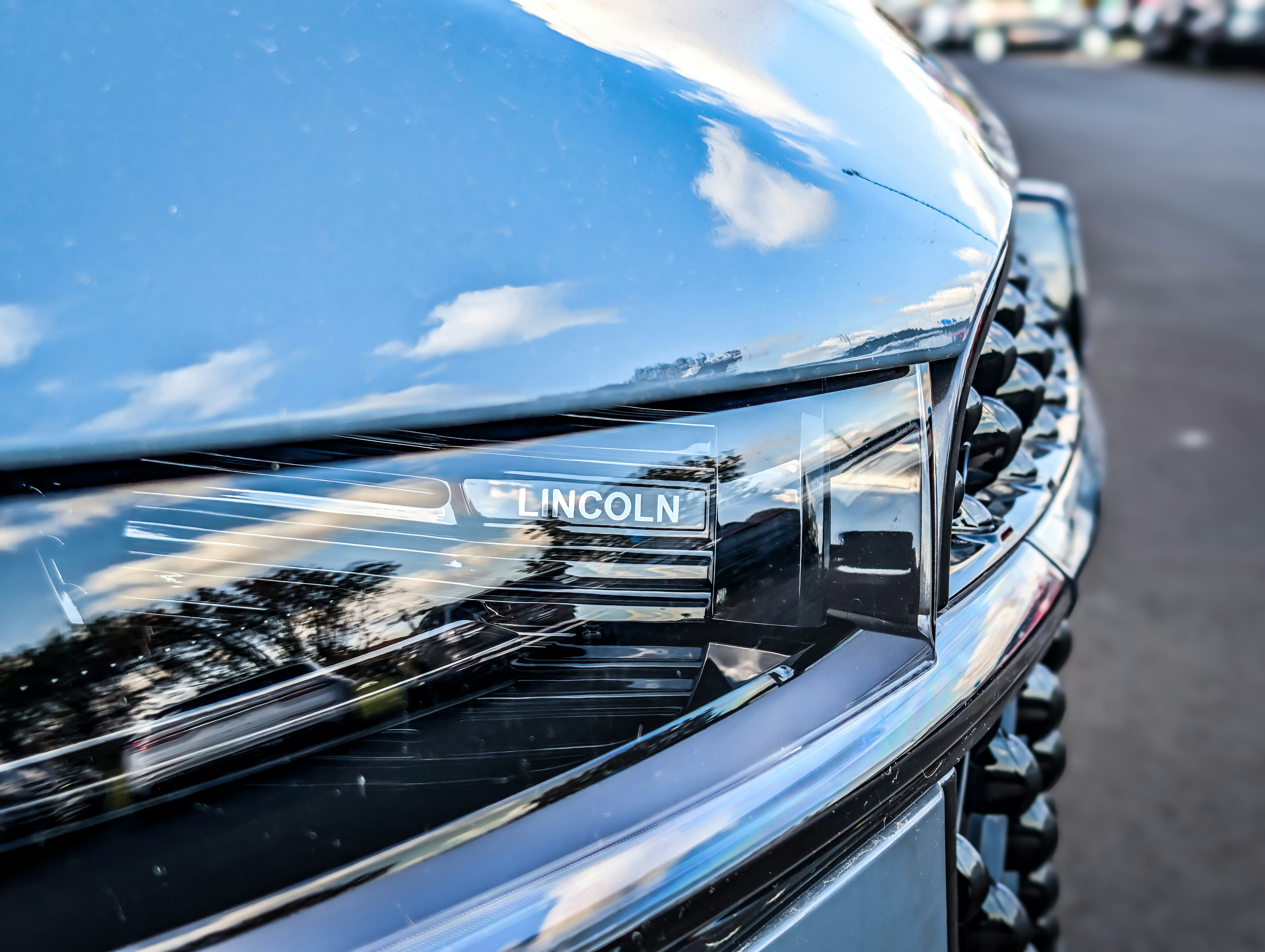 Family inspecting a used car at a dealership lot, comparing affordable vehicles under $20K