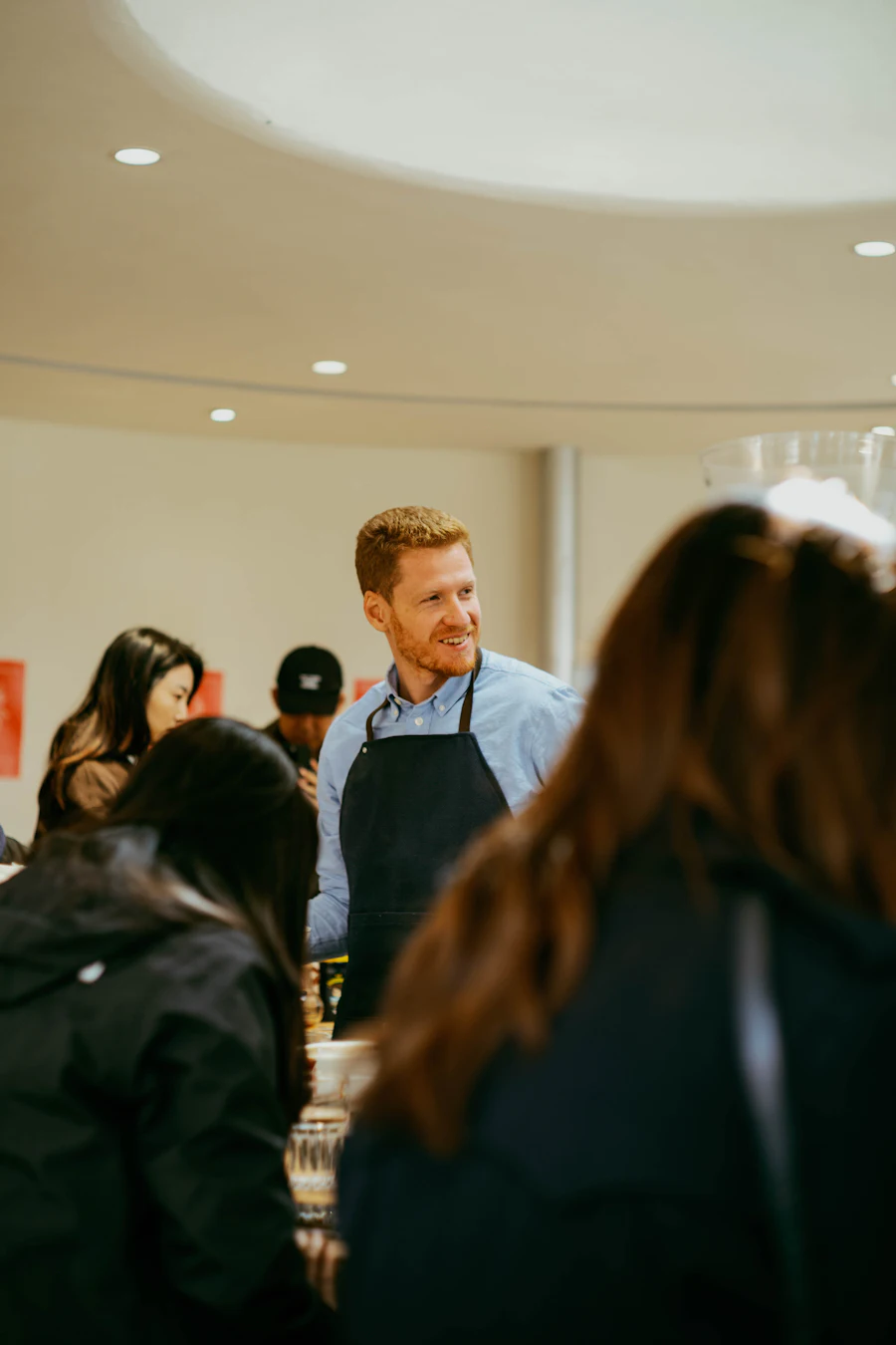 A shop assistant serving customers in a store