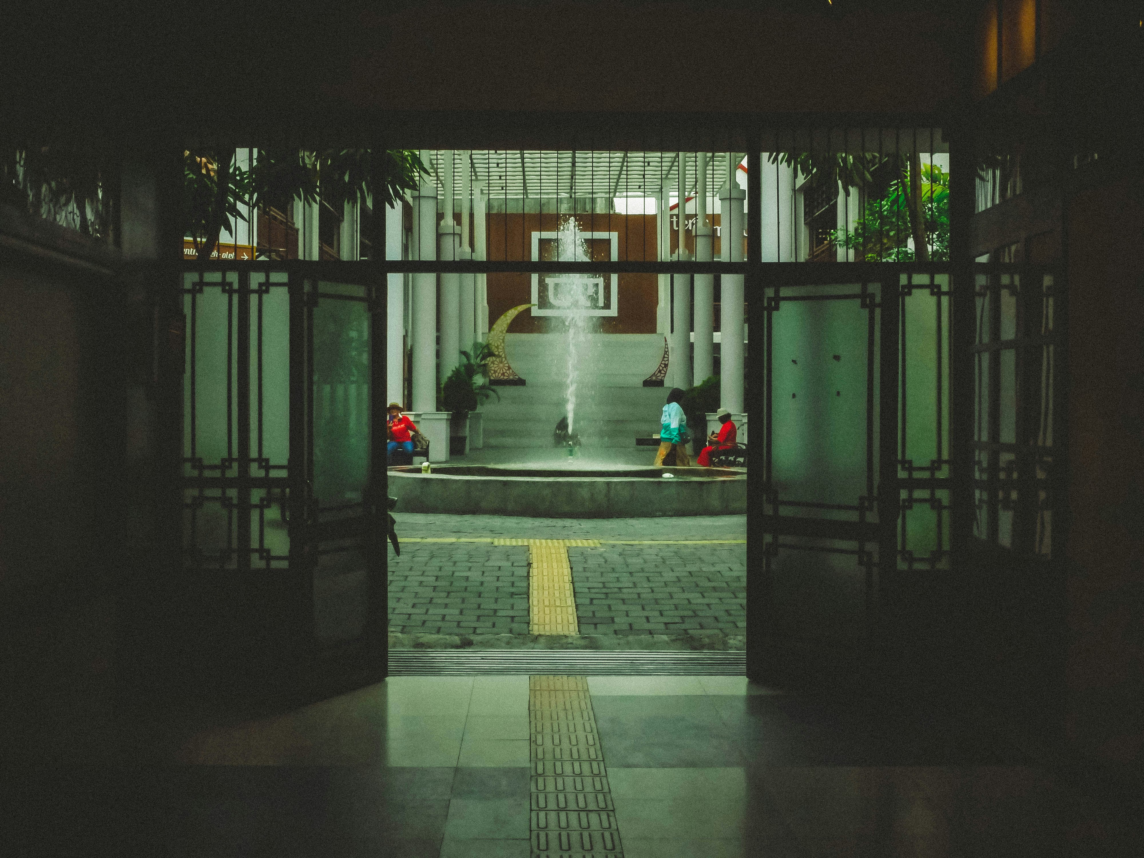 People gathered around a fountain in a courtyard.