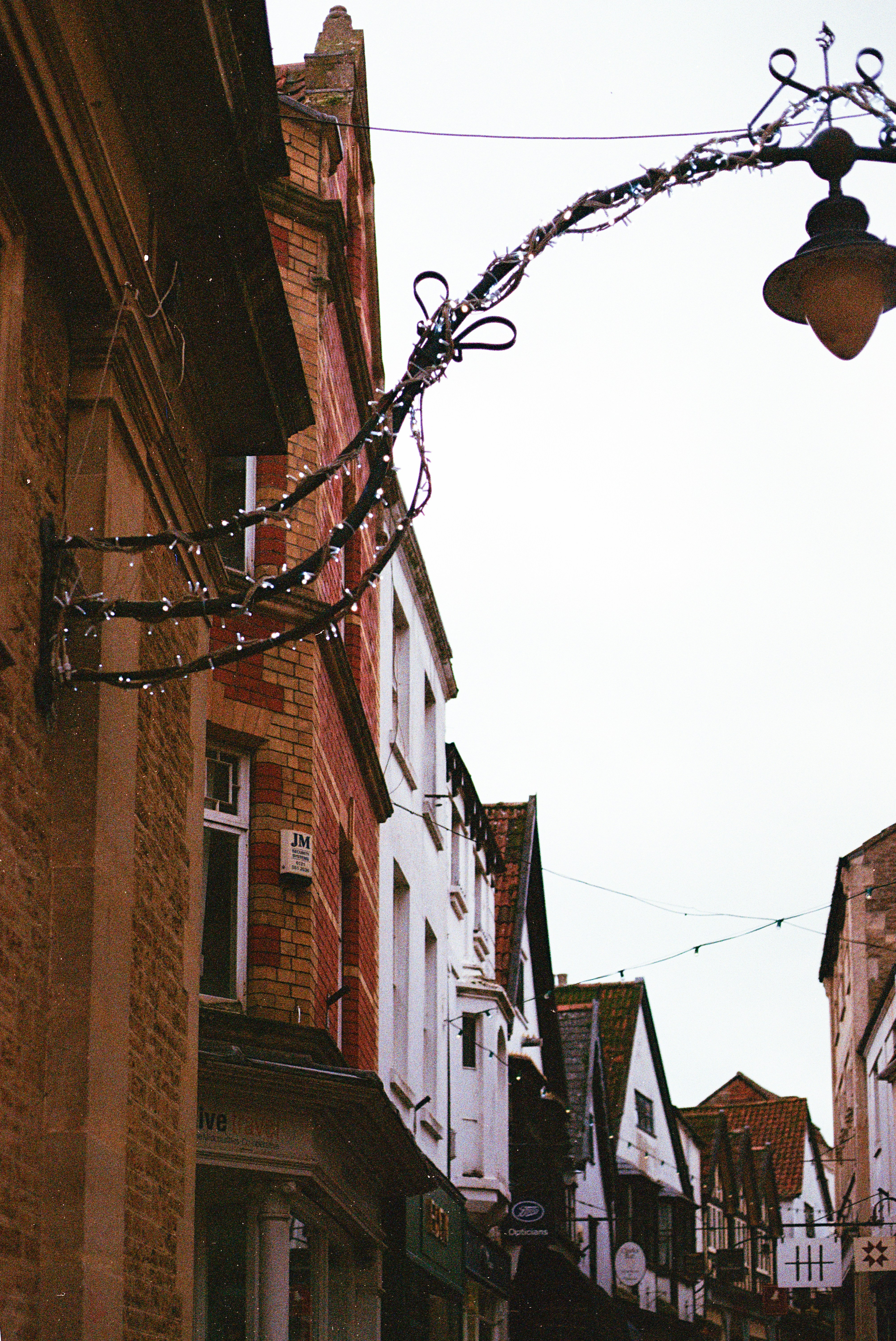 Street decorated with festive lights and garlands.