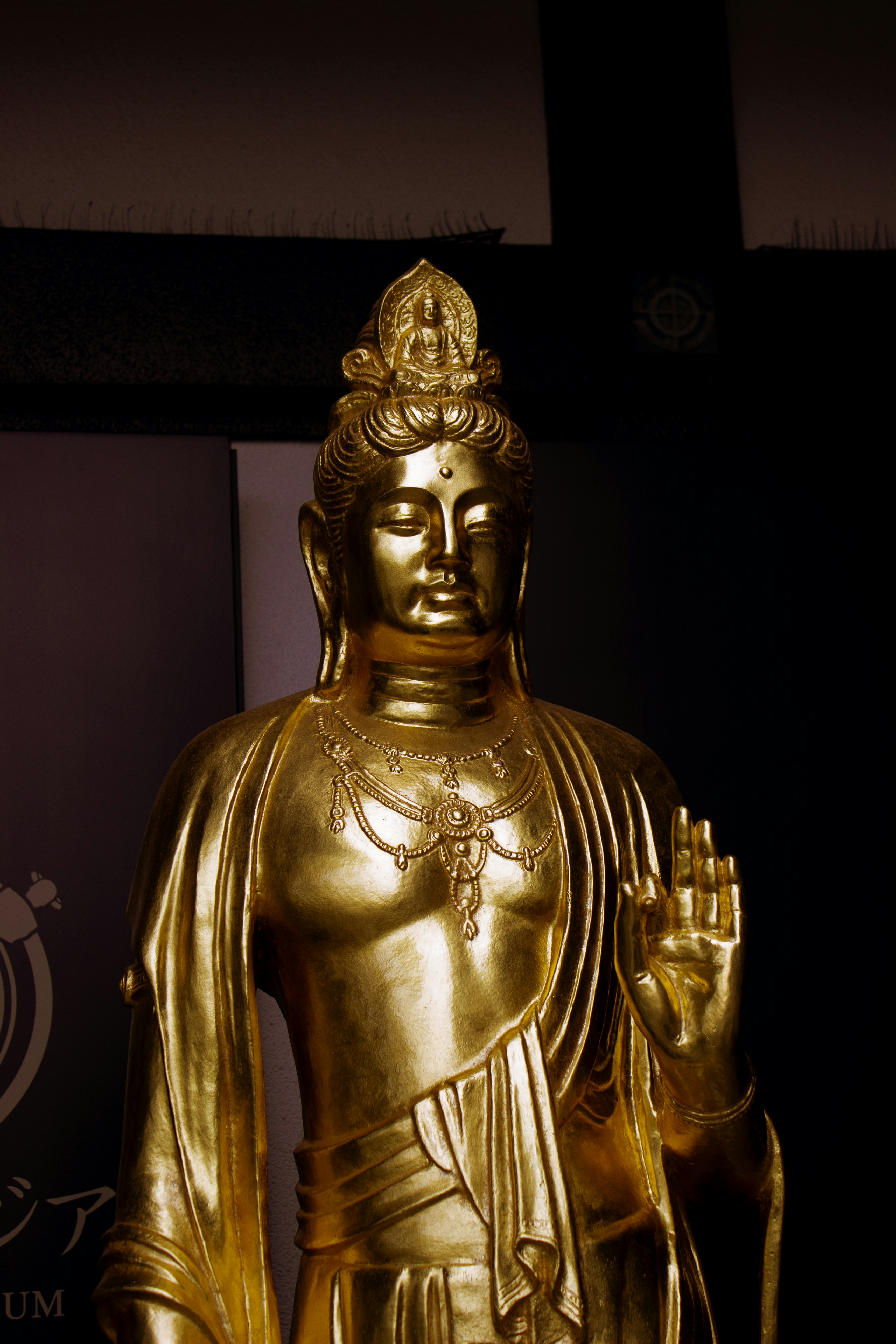 A golden statue of a meditating buddha