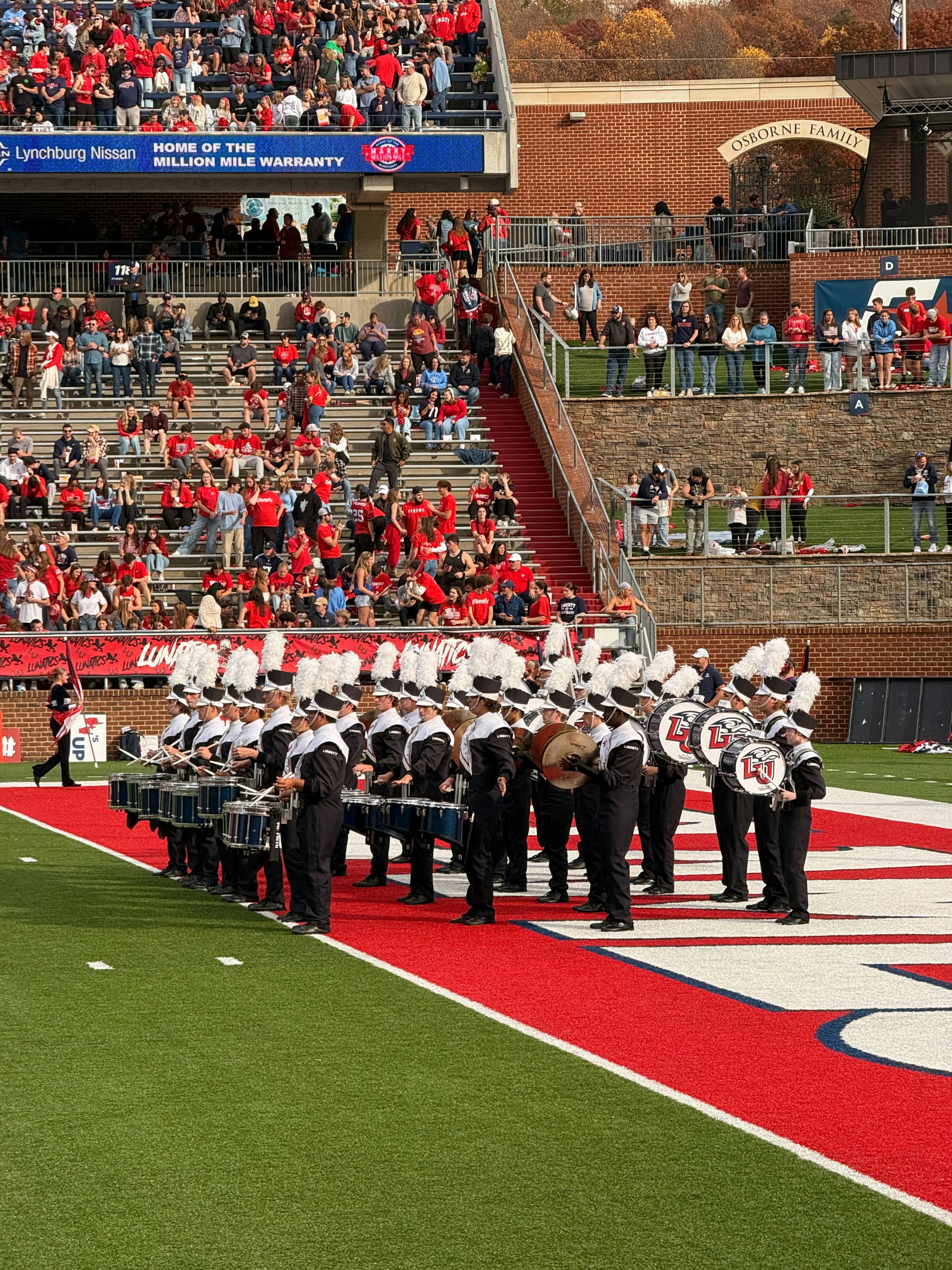 A marching band performs on a football field.