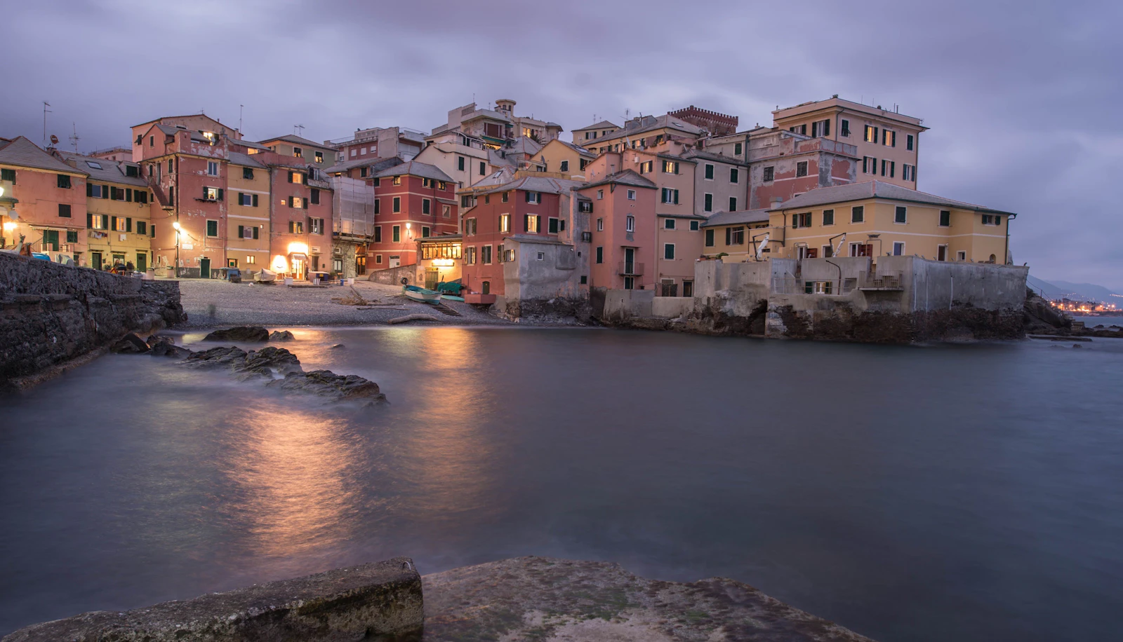 The pastel houses of Boccadasse, the fishing cove inside Genoa, at dusk