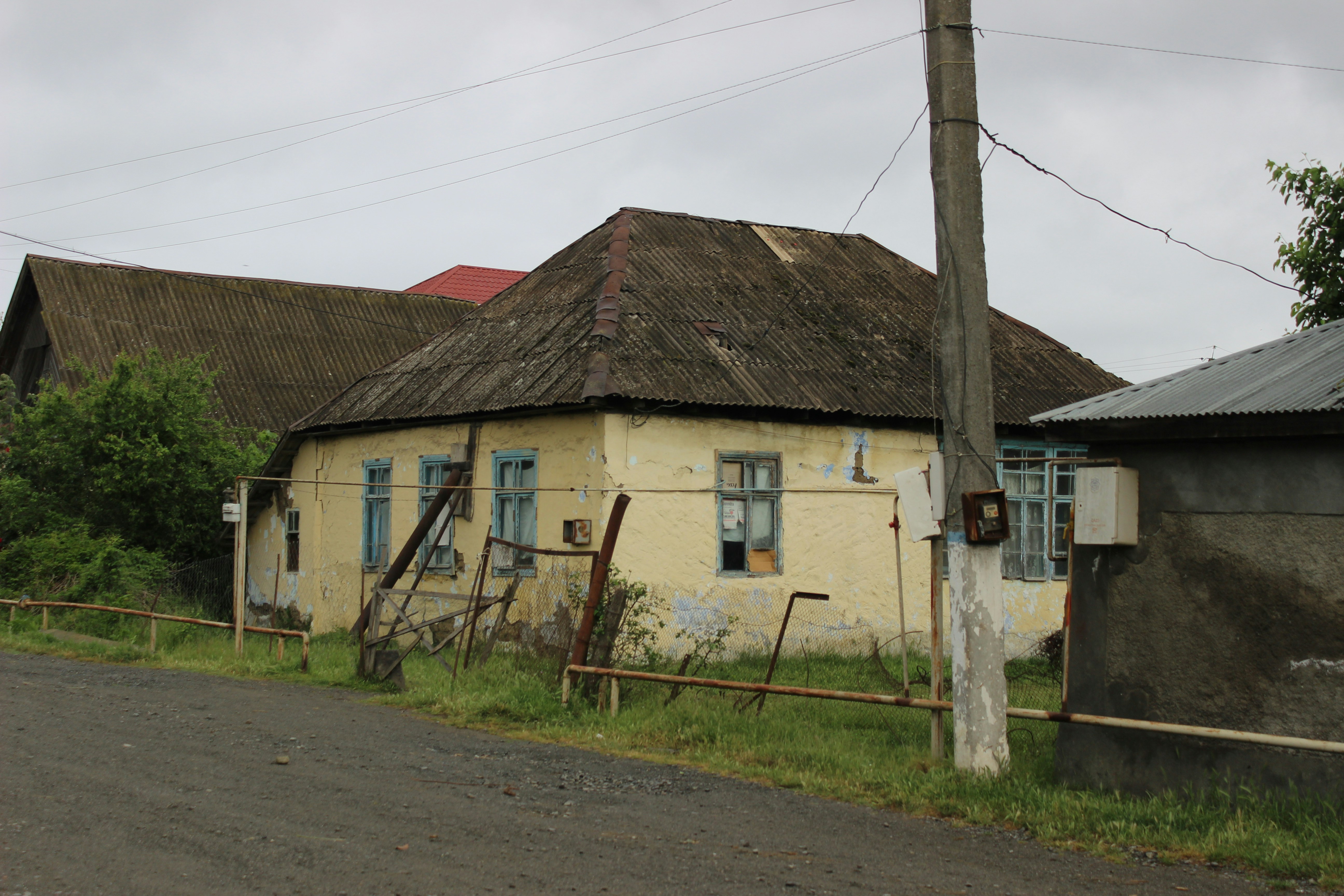Old yellow house with a weathered roof