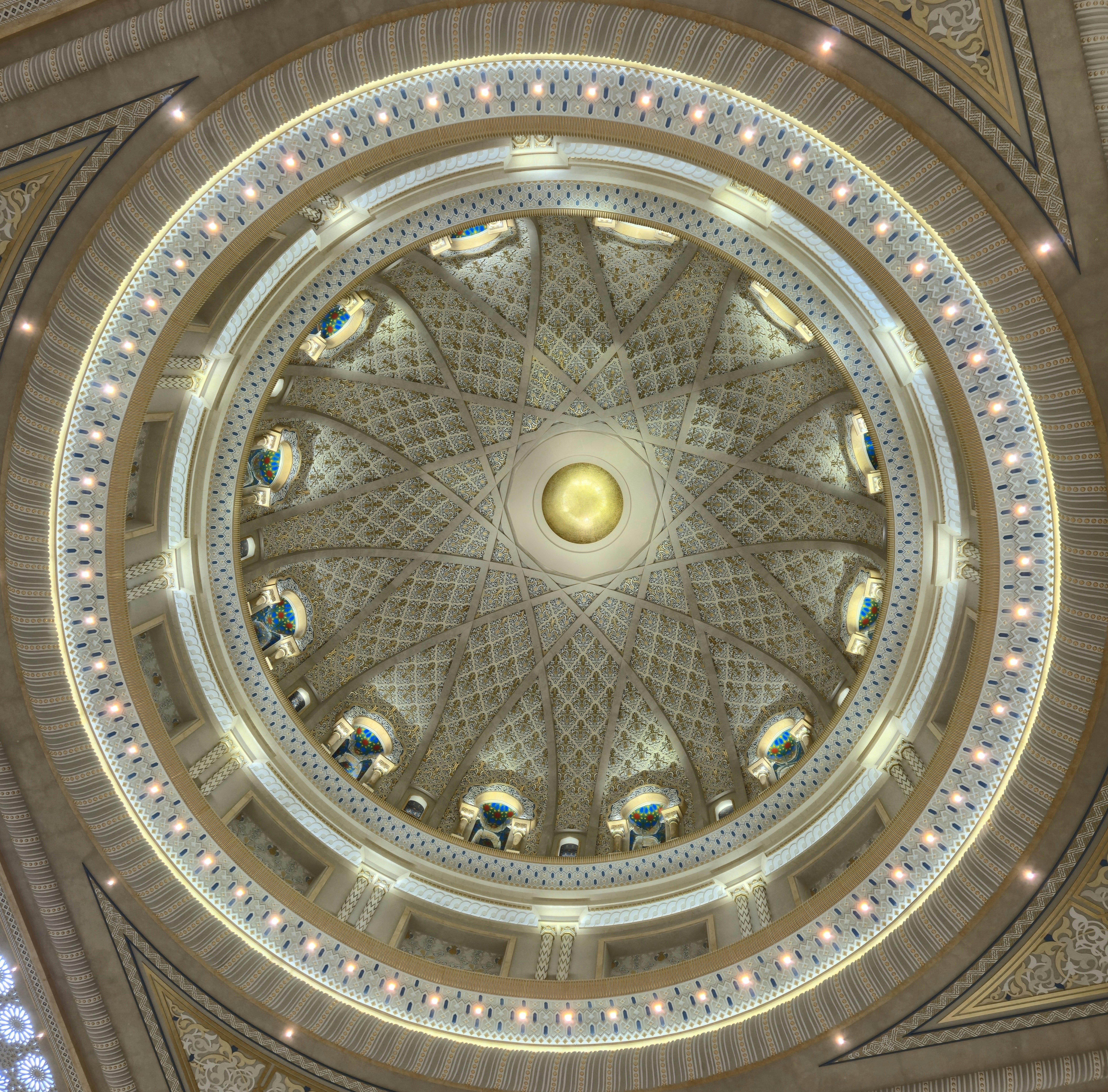 Intricate dome ceiling with ornate patterns and golden orb.