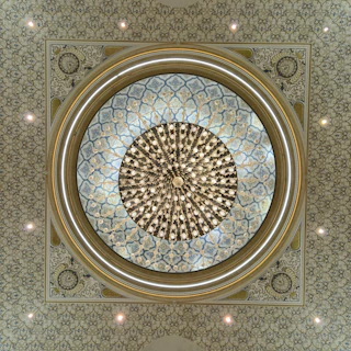 Ornate ceiling with a large circular chandelier.