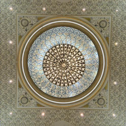 Ornate ceiling with a large circular chandelier.