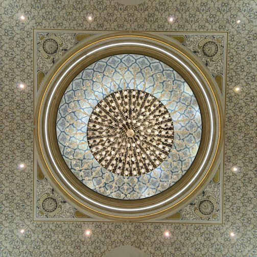 Ornate ceiling with a large circular chandelier.