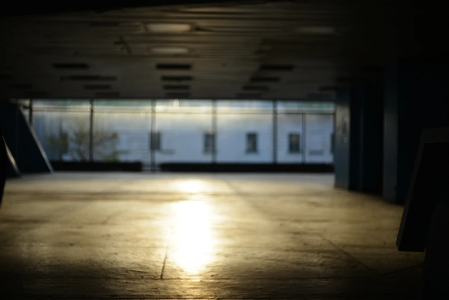 An empty swept concrete garage floor with daylight falling across it