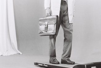 Man in lab coat holding briefcase on scale