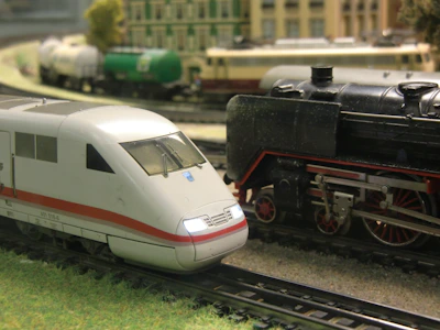 Modern train alongside vintage steam locomotive