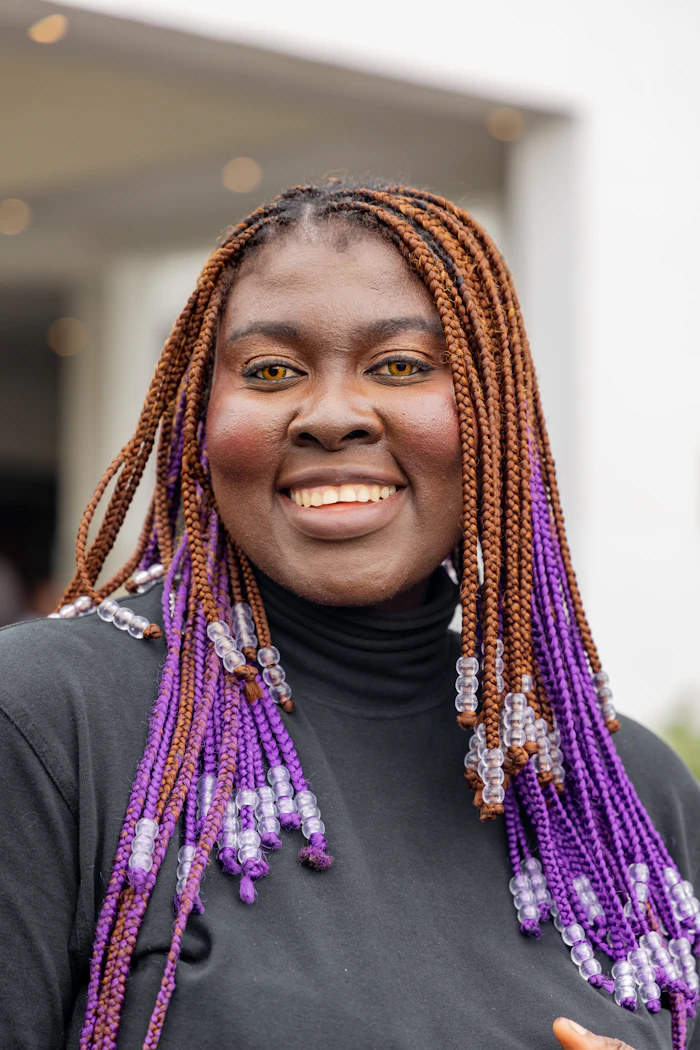 Smiling Black woman with braided hair