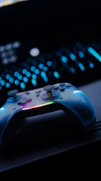 A white video game controller with colorful lights.