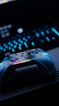 A white video game controller with colorful lights.
