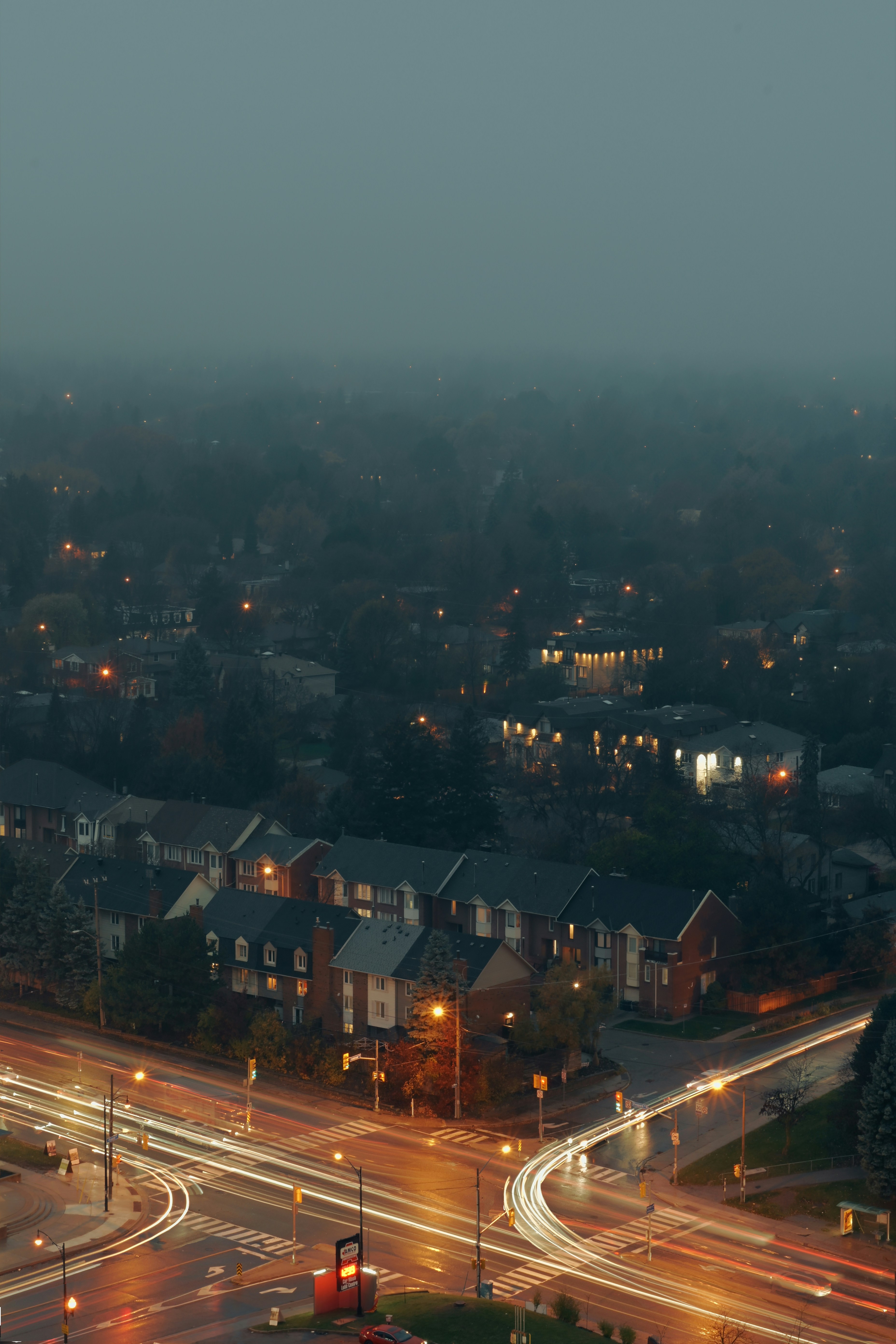 Cityscape with light trails at dusk in fog