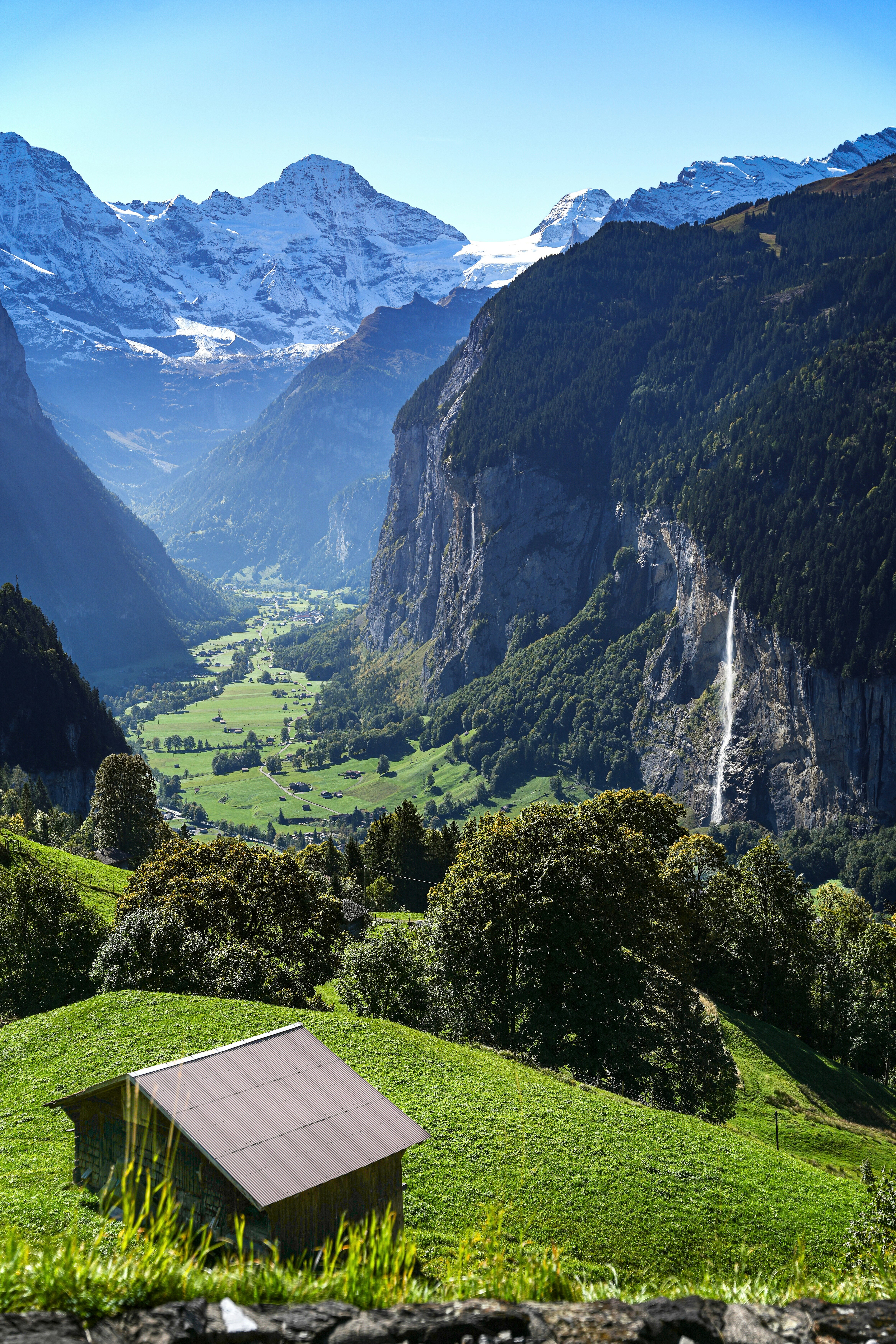 Valley with waterfall and snow-capped mountains